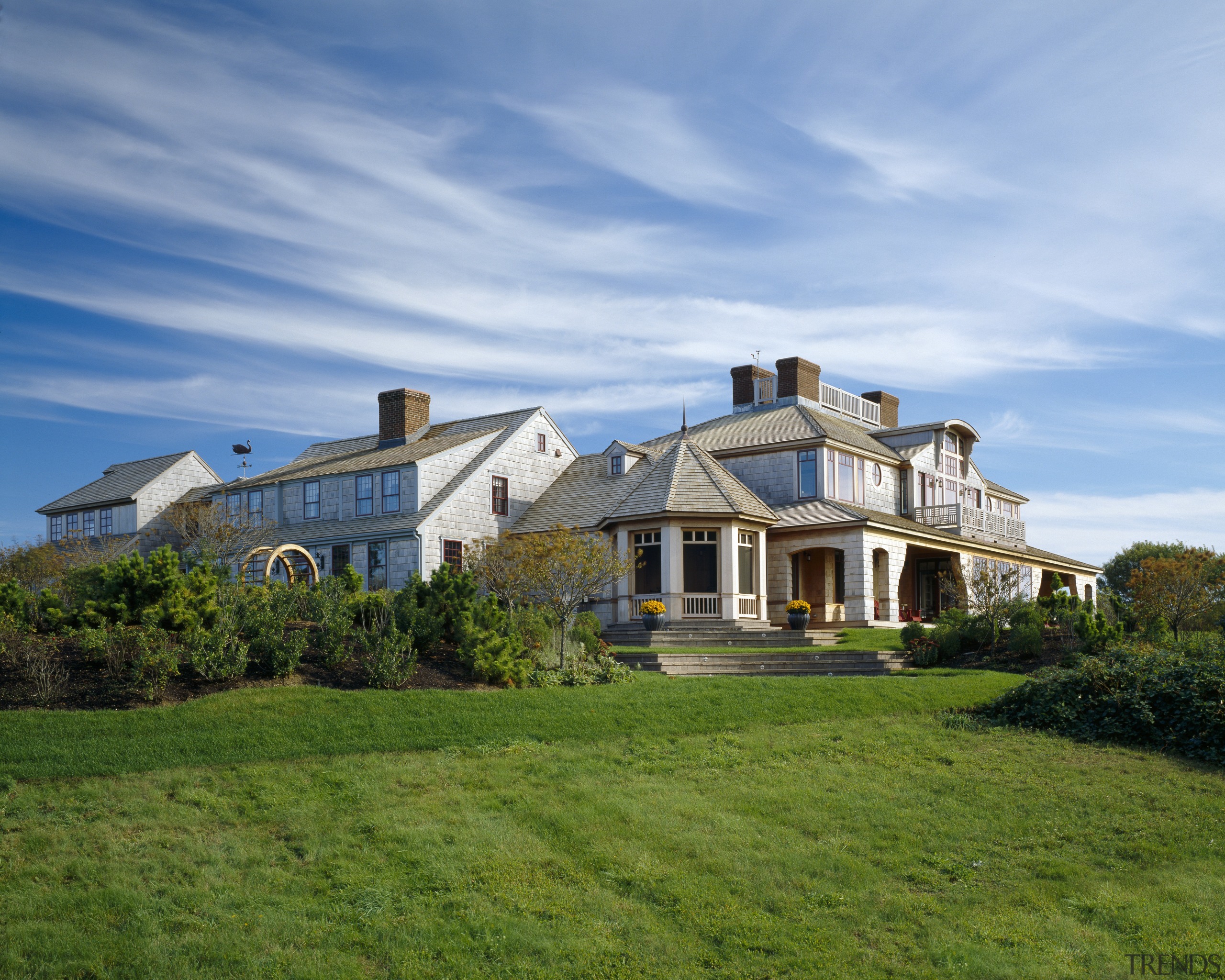Exterior view of a large cottage with cedar cloud, cottage, estate, facade, farmhouse, grass, home, house, land lot, landscape, lawn, mansion, property, real estate, residential area, roof, sky, suburb, villa, teal