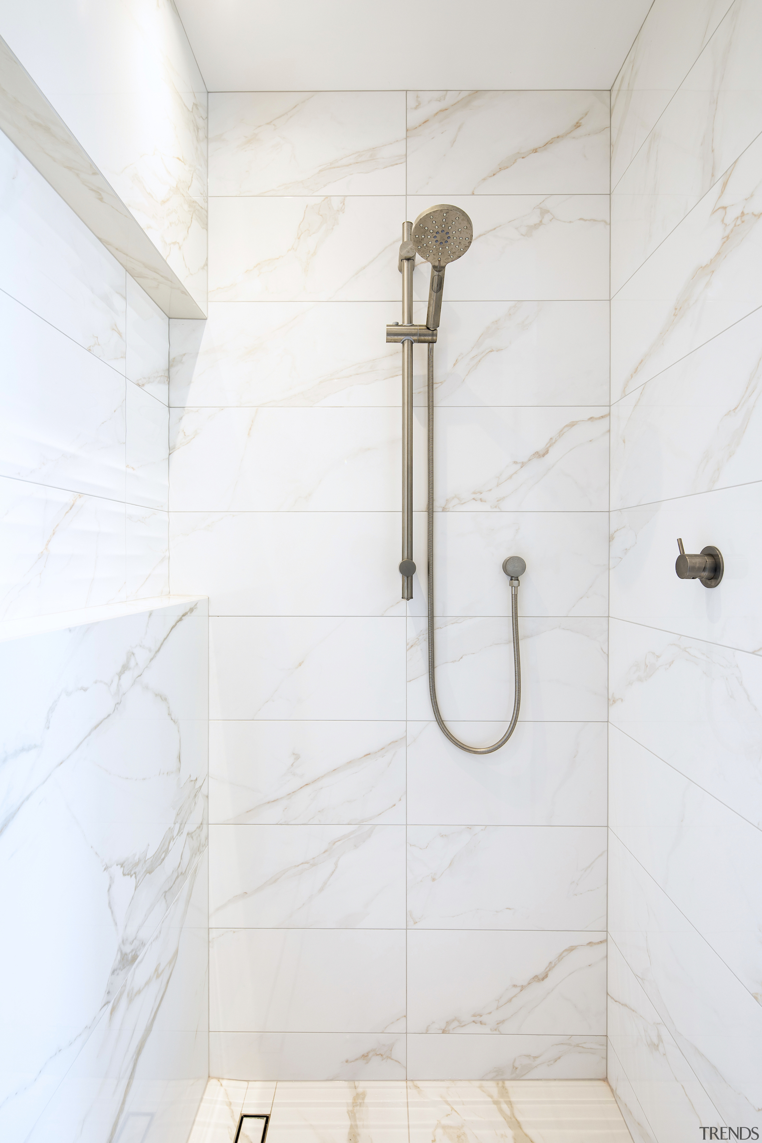 The long custom shower stall includes a soap 