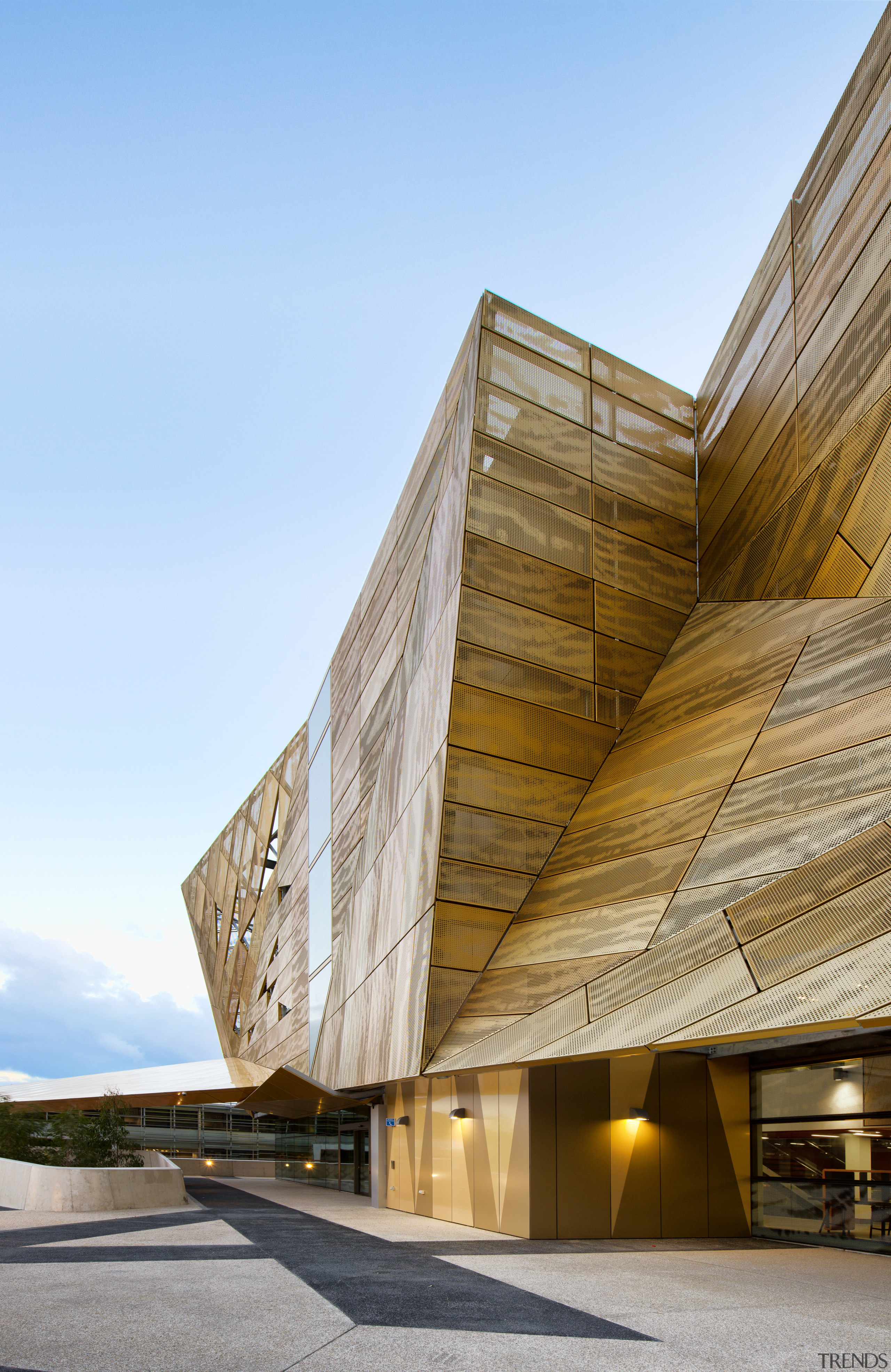 A golden canopy and veil enliven the exterior architecture, building, facade, sky, structure, sunlight, wood, teal, brown