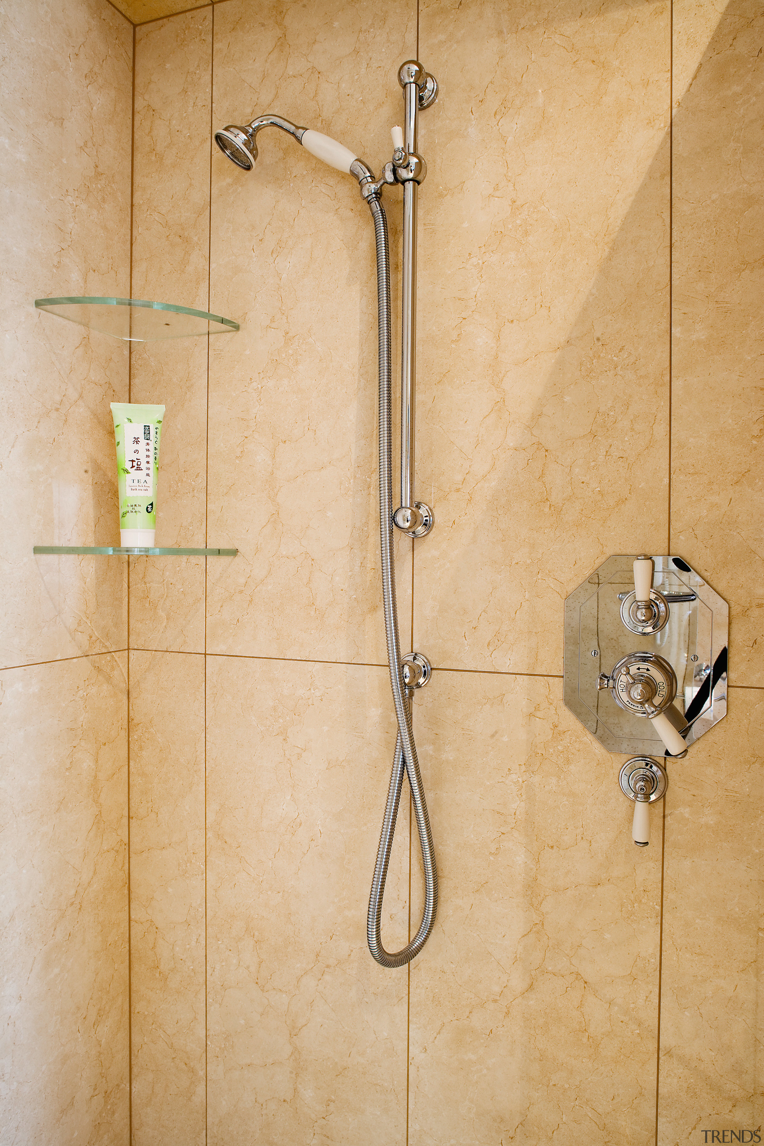 View of a tiled shower enclosure with chrome bathroom, plumbing fixture, shower, tap, tile, wall, orange
