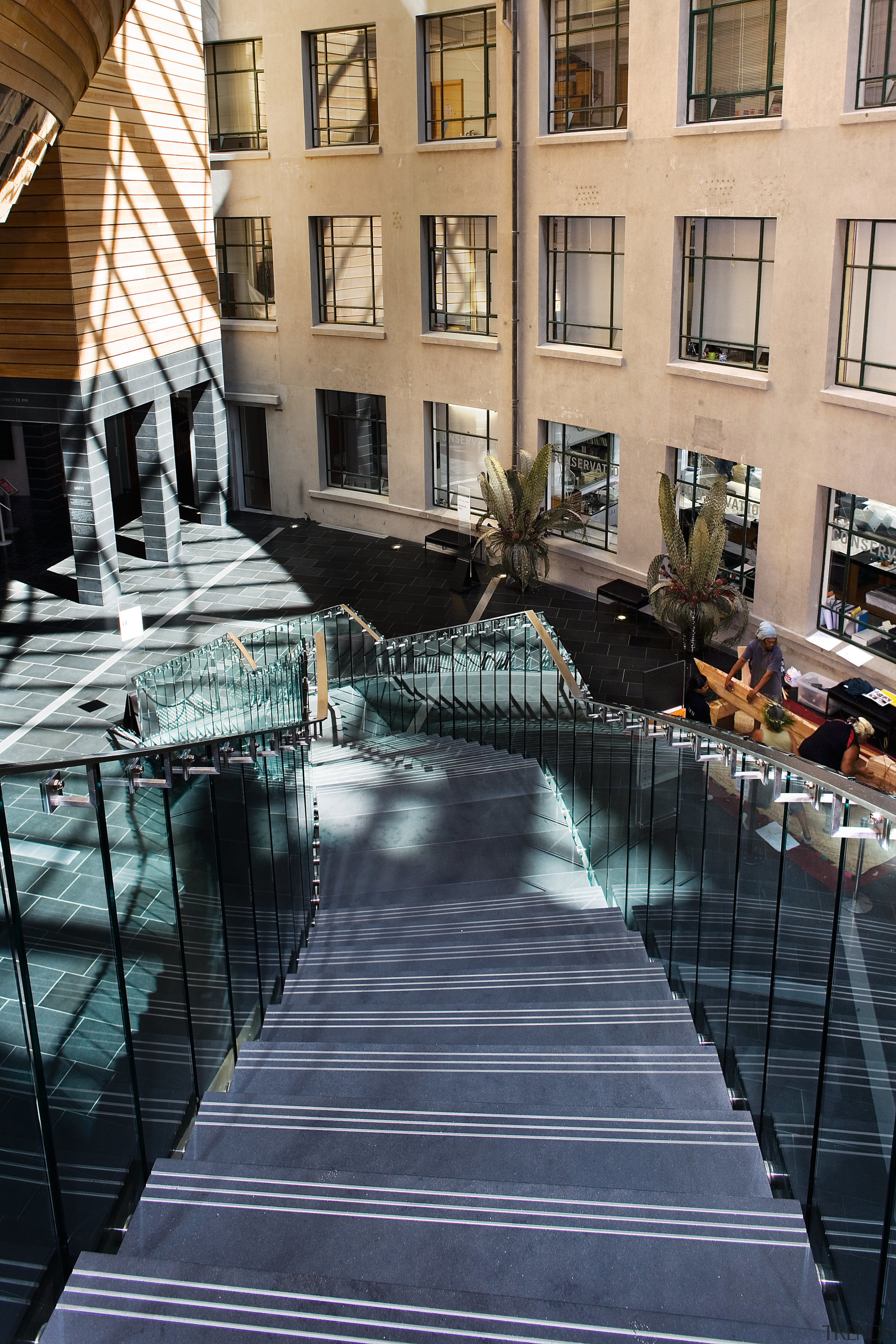 A view of the Auckland Museum. - A architecture, building, condominium, daytime, facade, metropolitan area, reflection, urban area, walkway, water, window, black