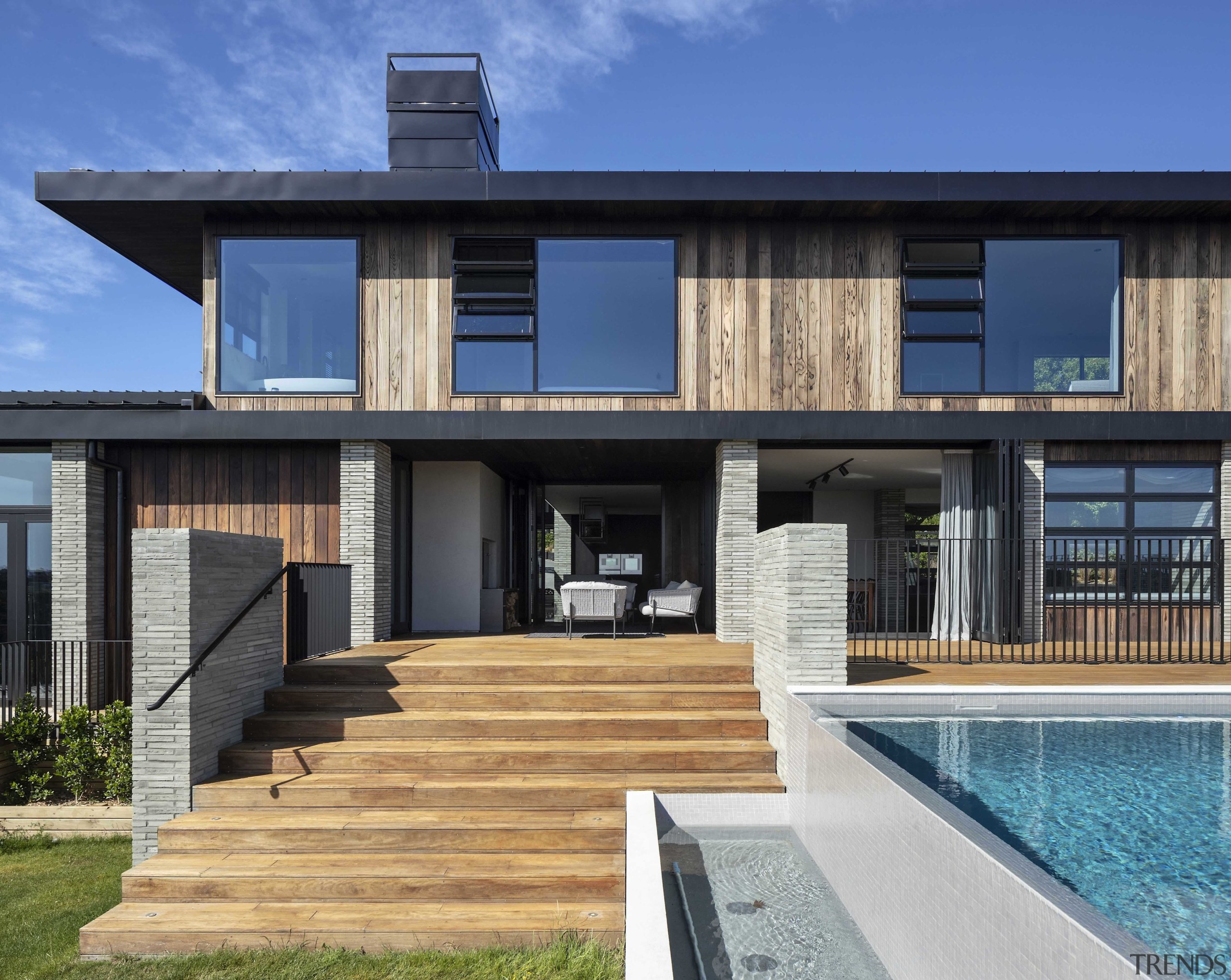 Generous timber steps alongside the infinity pool lead 