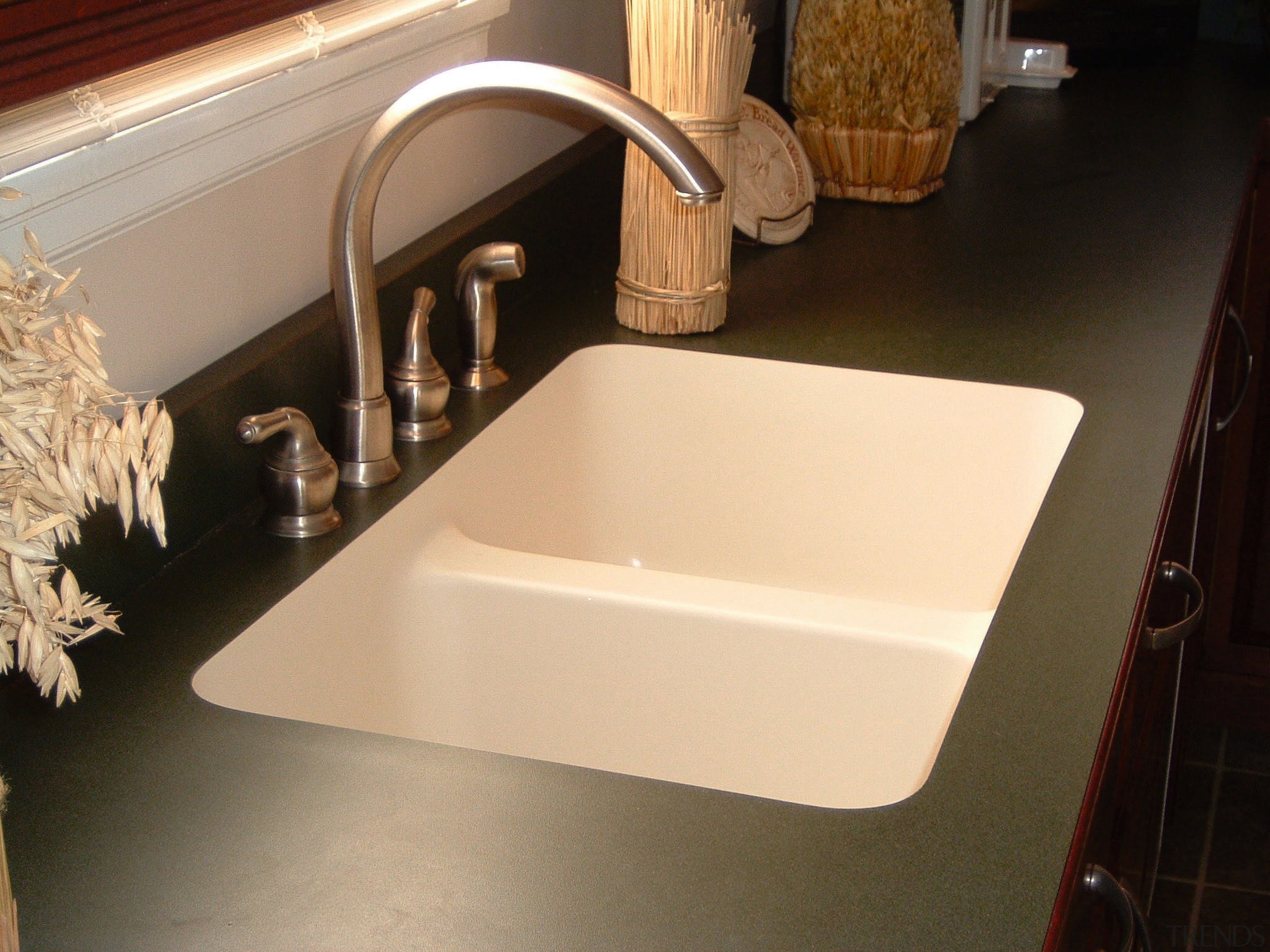 View of kitchen countertop showing undermount sink. bathroom sink, countertop, floor, plumbing fixture, product design, sink, tap, orange, black