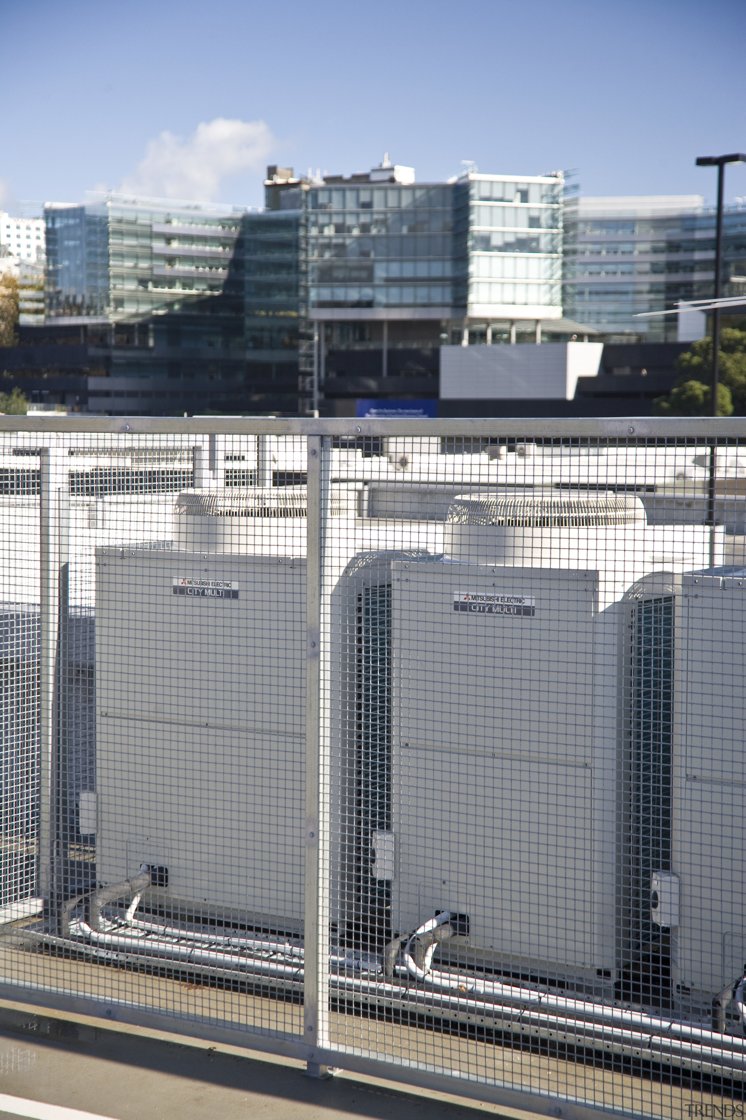 View of air conditioning and ventilation system at building, city, facade, fence, metropolis, metropolitan area, residential area, skyscraper, tower block, urban area, gray