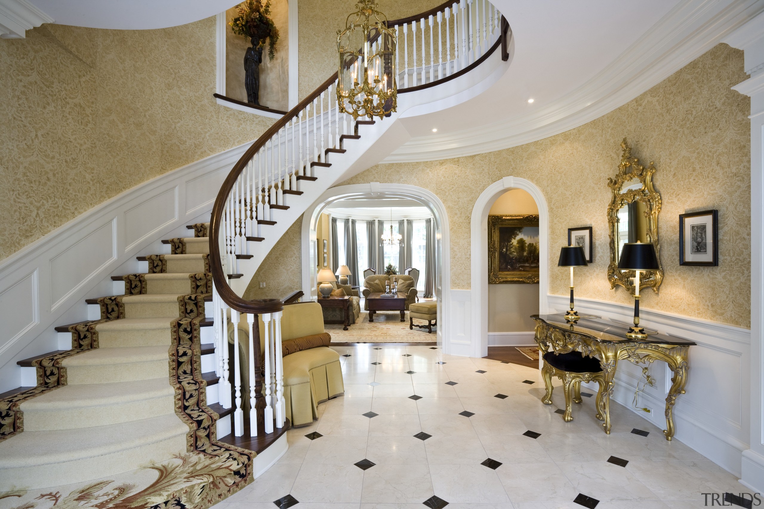 View of a sweeping staircase with dark-stained timber baluster, ceiling, estate, floor, flooring, handrail, home, interior design, lobby, property, real estate, stairs, gray, brown