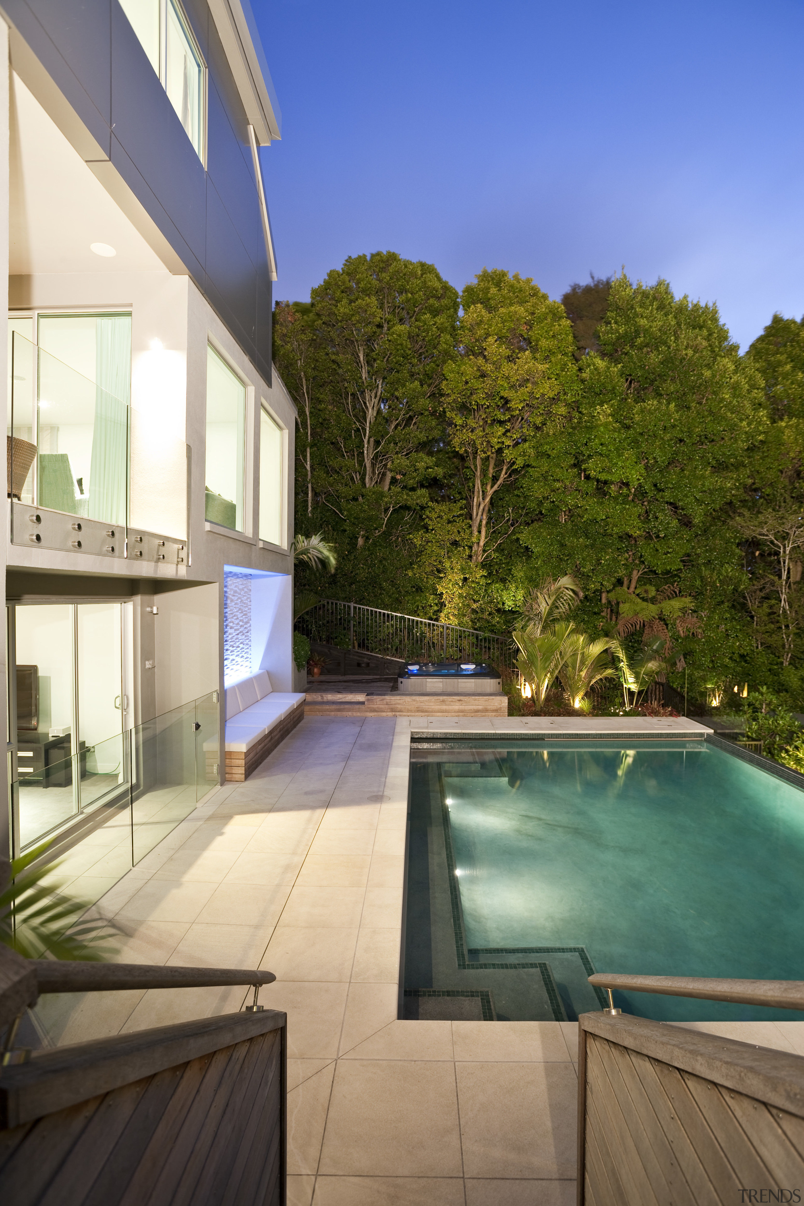 View of sleek poolscape with textured stone wall, apartment, architecture, backyard, estate, home, house, property, real estate, swimming pool, villa, brown