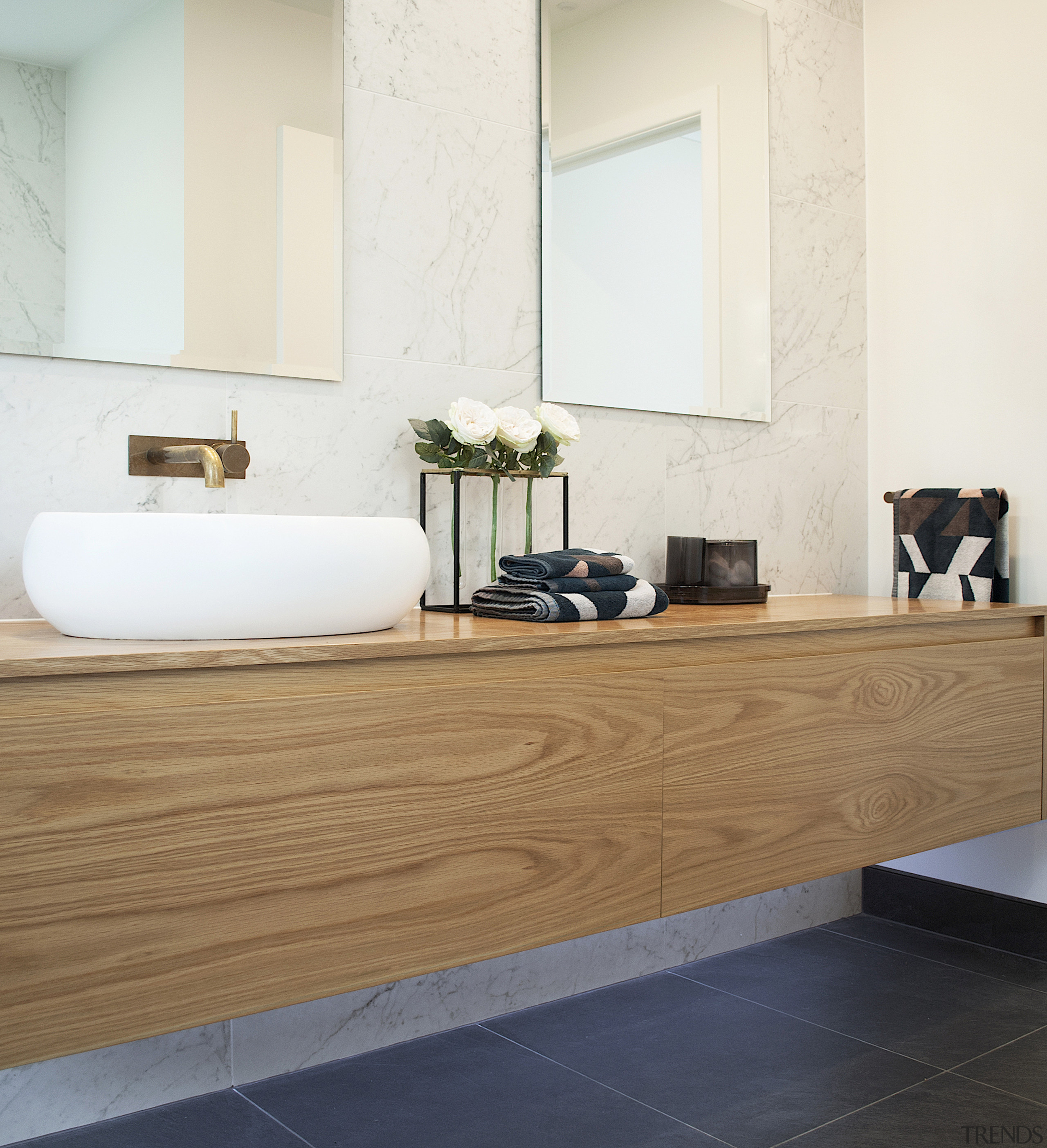 The large vanity creates sufficient storage for the white