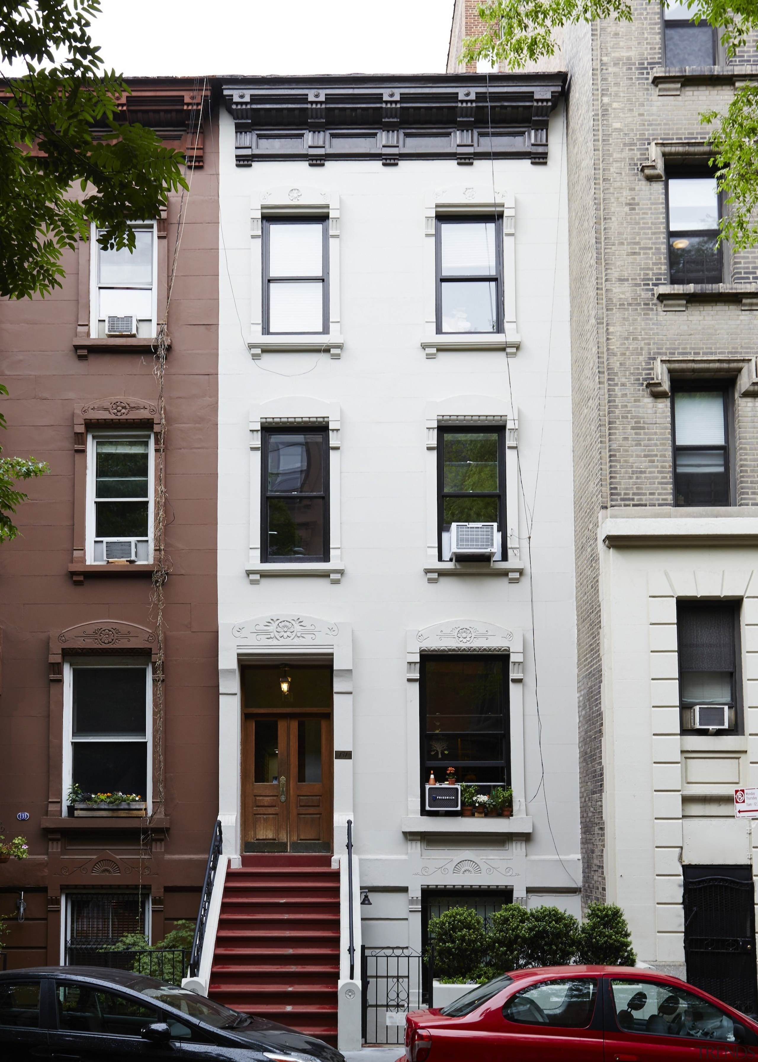 Outside, the home blends into its neighbours - apartment, architecture, building, door, facade, home, house, neighbourhood, property, real estate, residential area, window, white