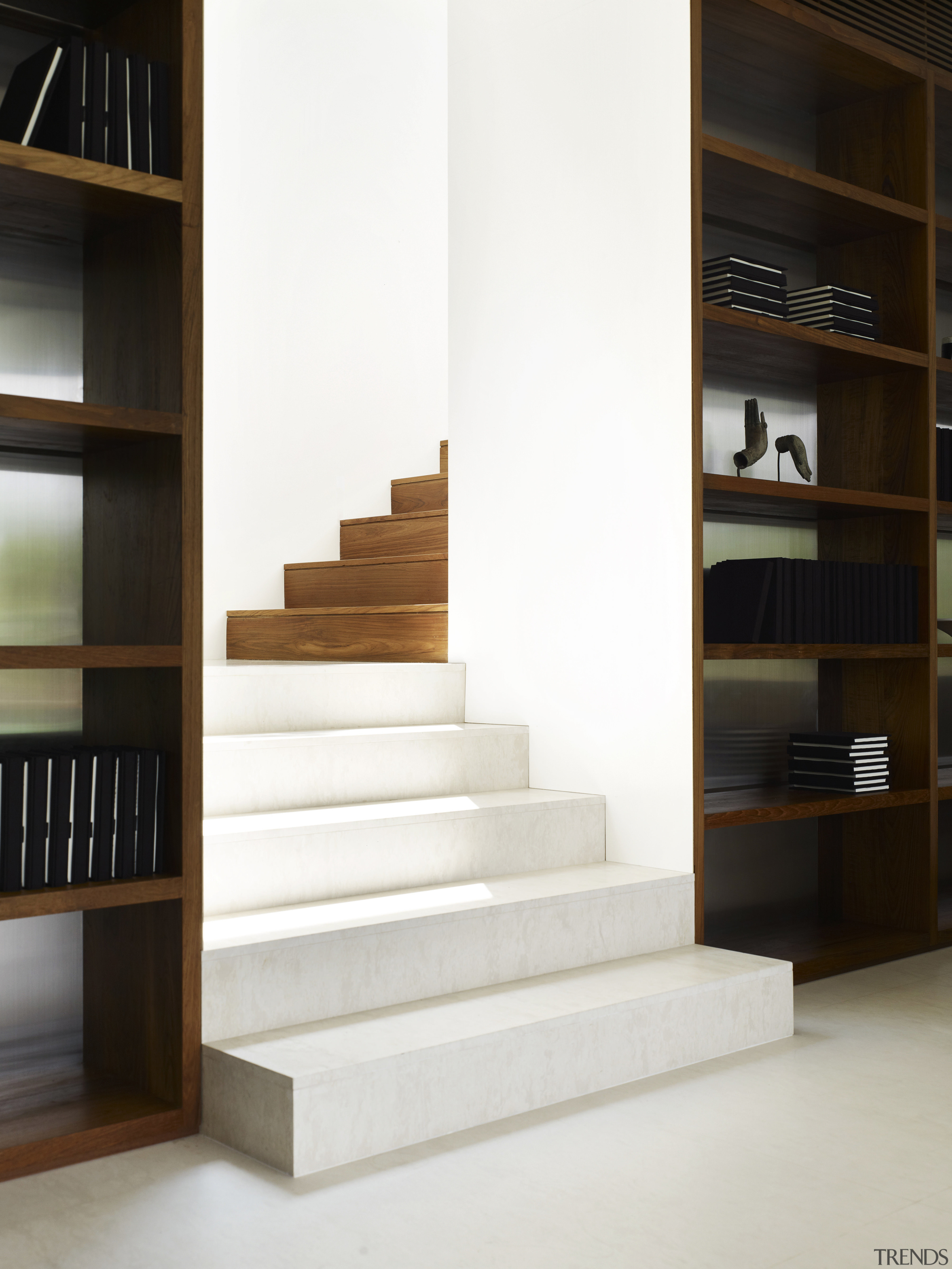 Limestone stairs in this new city house give bookcase, floor, flooring, furniture, interior design, product design, shelf, shelving, stairs, white, black