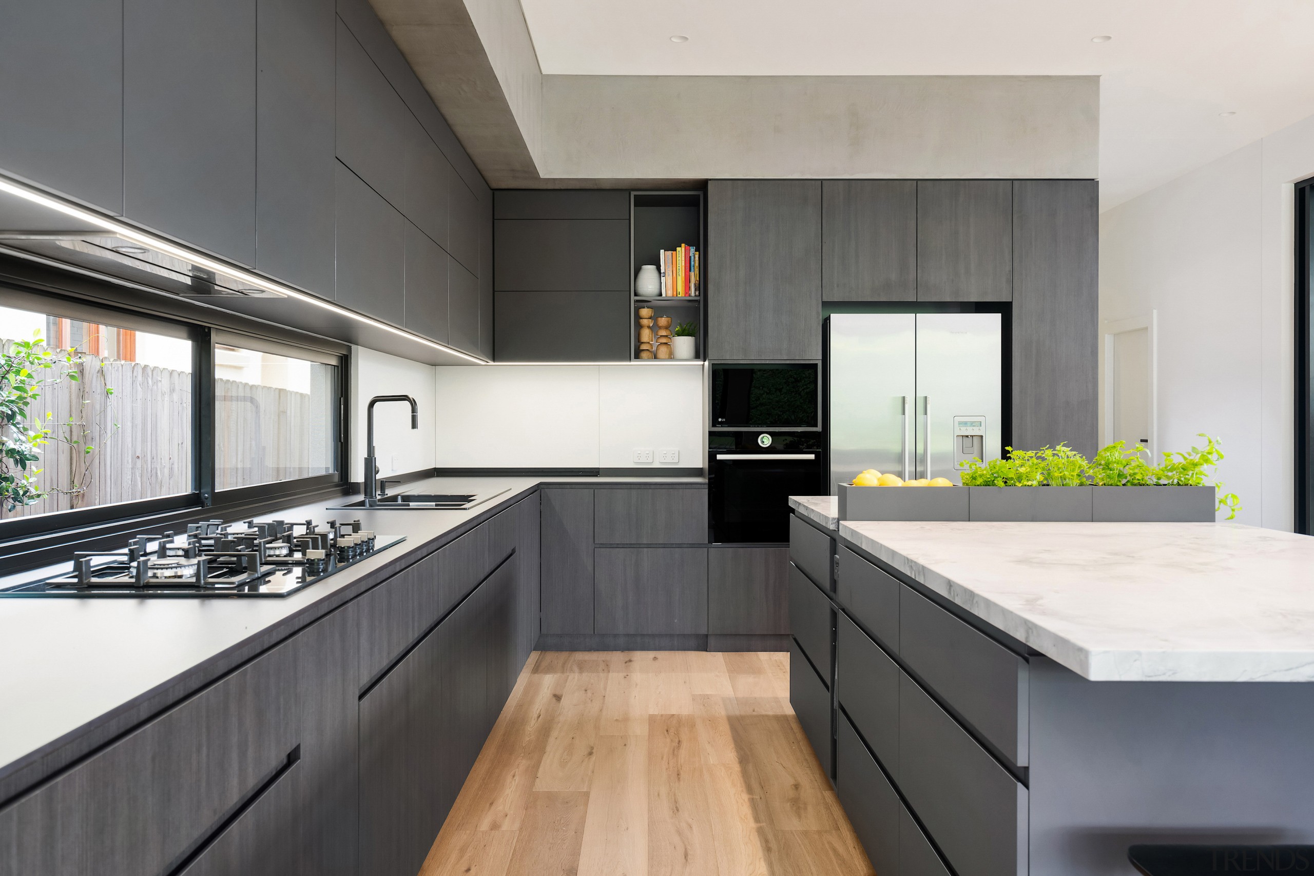 Recessed cabinetry pulls add to the kitchen's minimalist, 