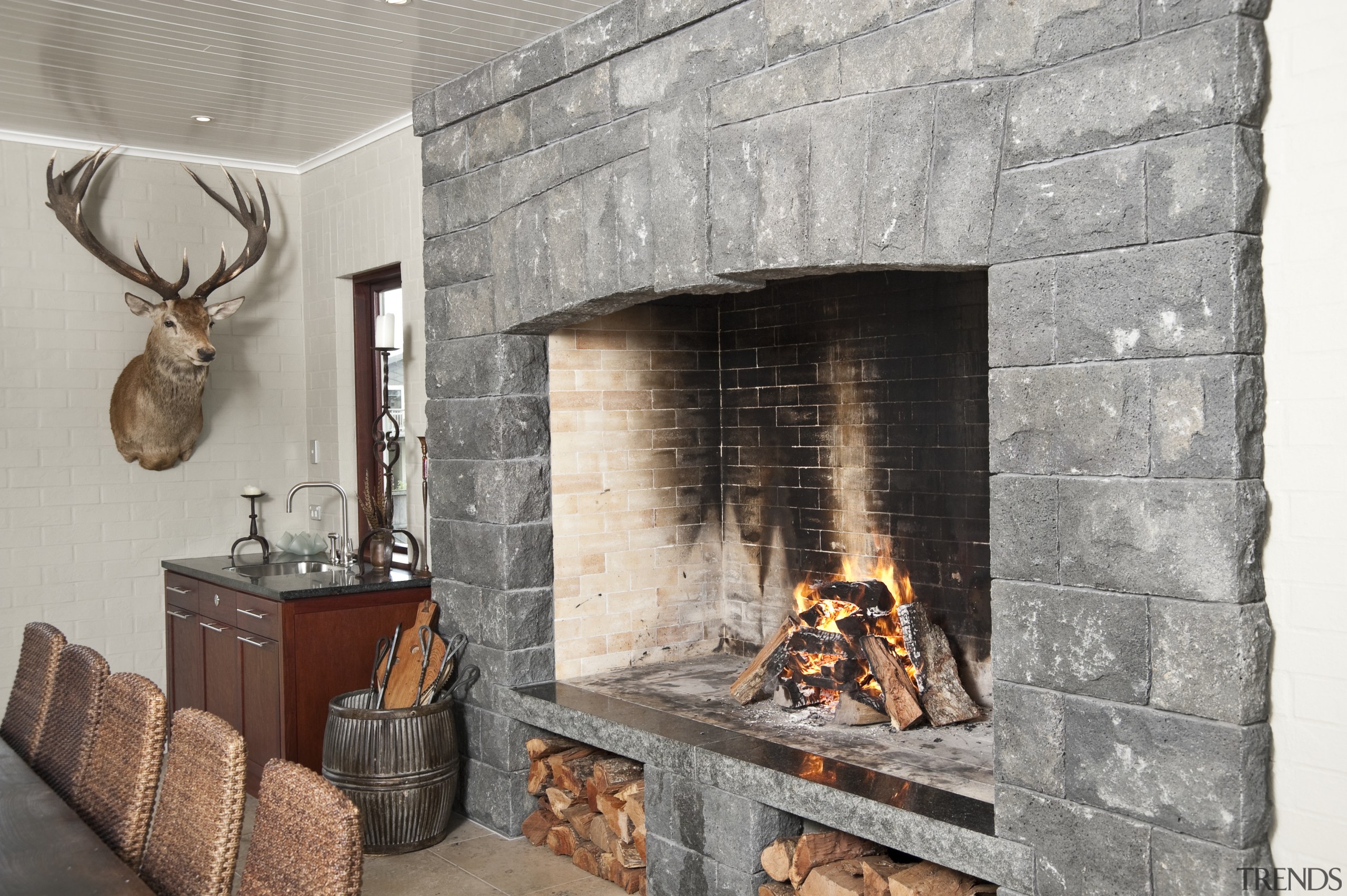 In the dining area of the home this fireplace, hearth, interior design, wood burning stove, gray