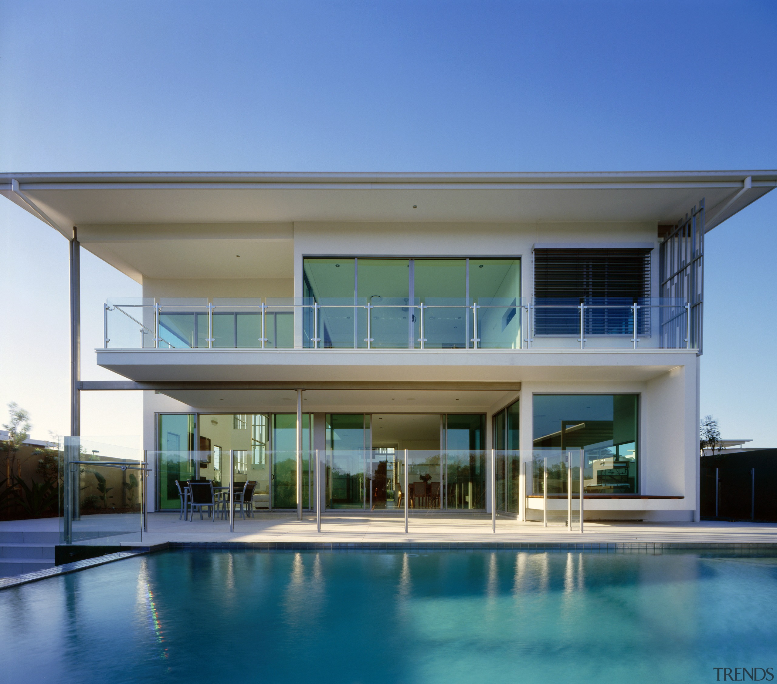 exterior view of the outdoor area of this architecture, condominium, estate, facade, home, house, property, real estate, swimming pool, villa, window, teal