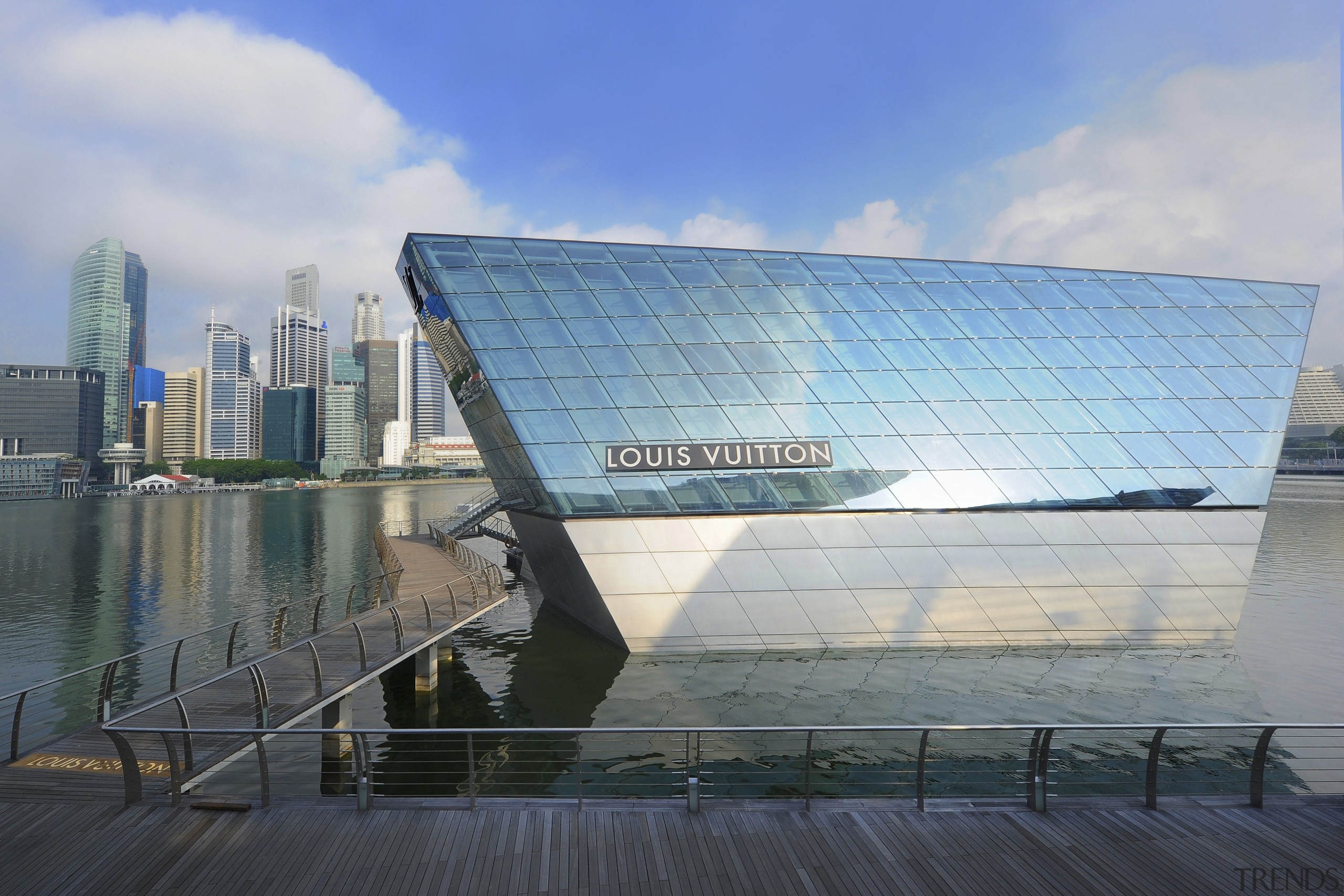 The Louis Vuitton Island Maison in Singapore can architecture, building, corporate headquarters, daytime, headquarters, landmark, metropolitan area, reflection, sky, water, gray, teal