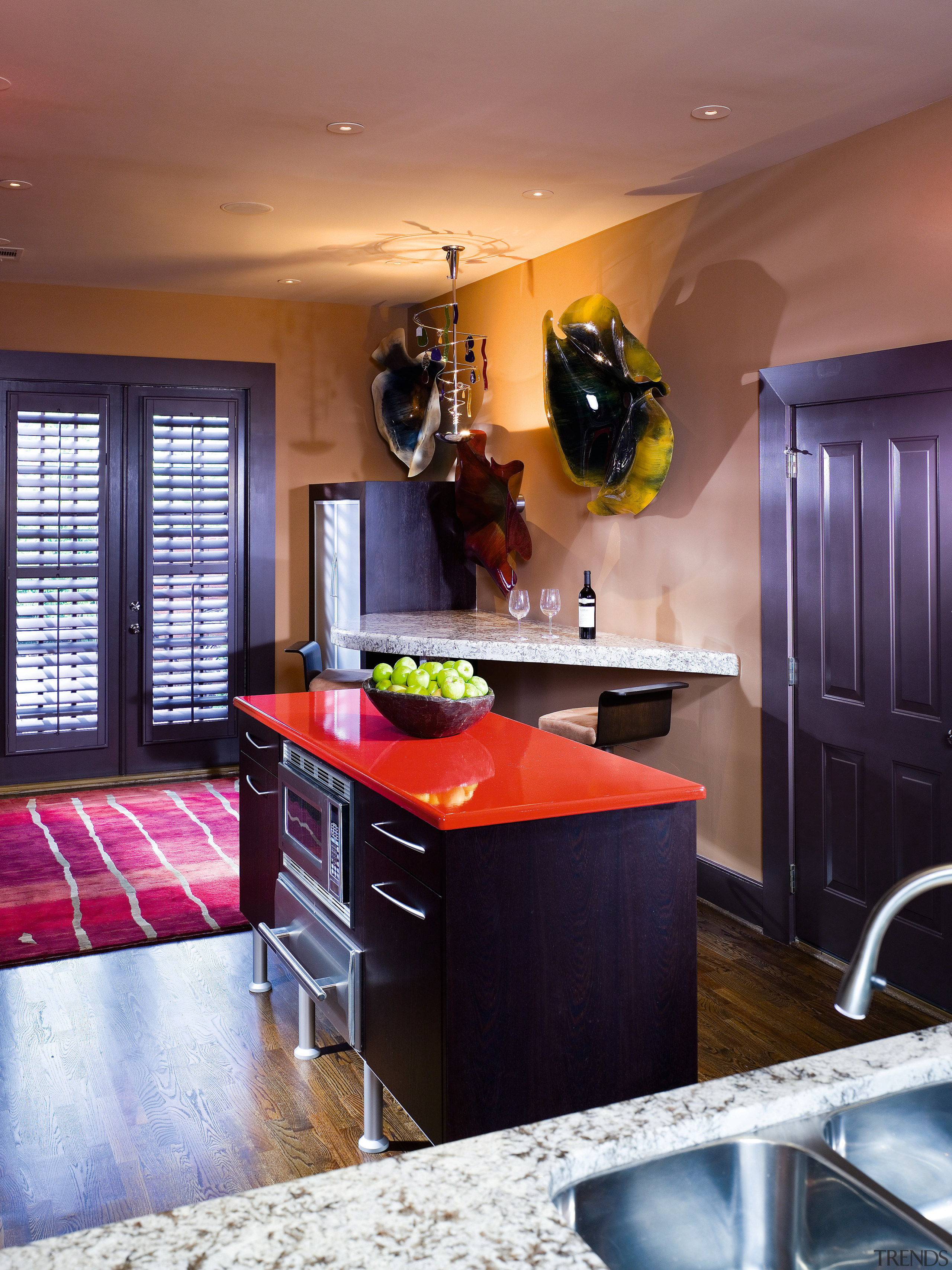 A view of this kitchen featuring black cabinetry, cabinetry, ceiling, countertop, home, interior design, kitchen, living room, room, red