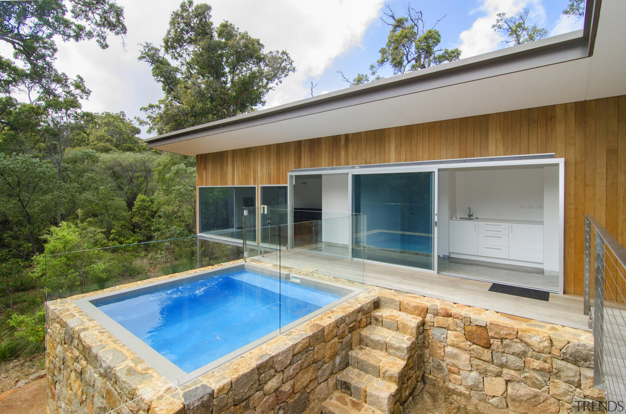 Natural stone surrouinds the plunge pool in this architecture, estate, home, house, property, real estate, swimming pool, villa, brown