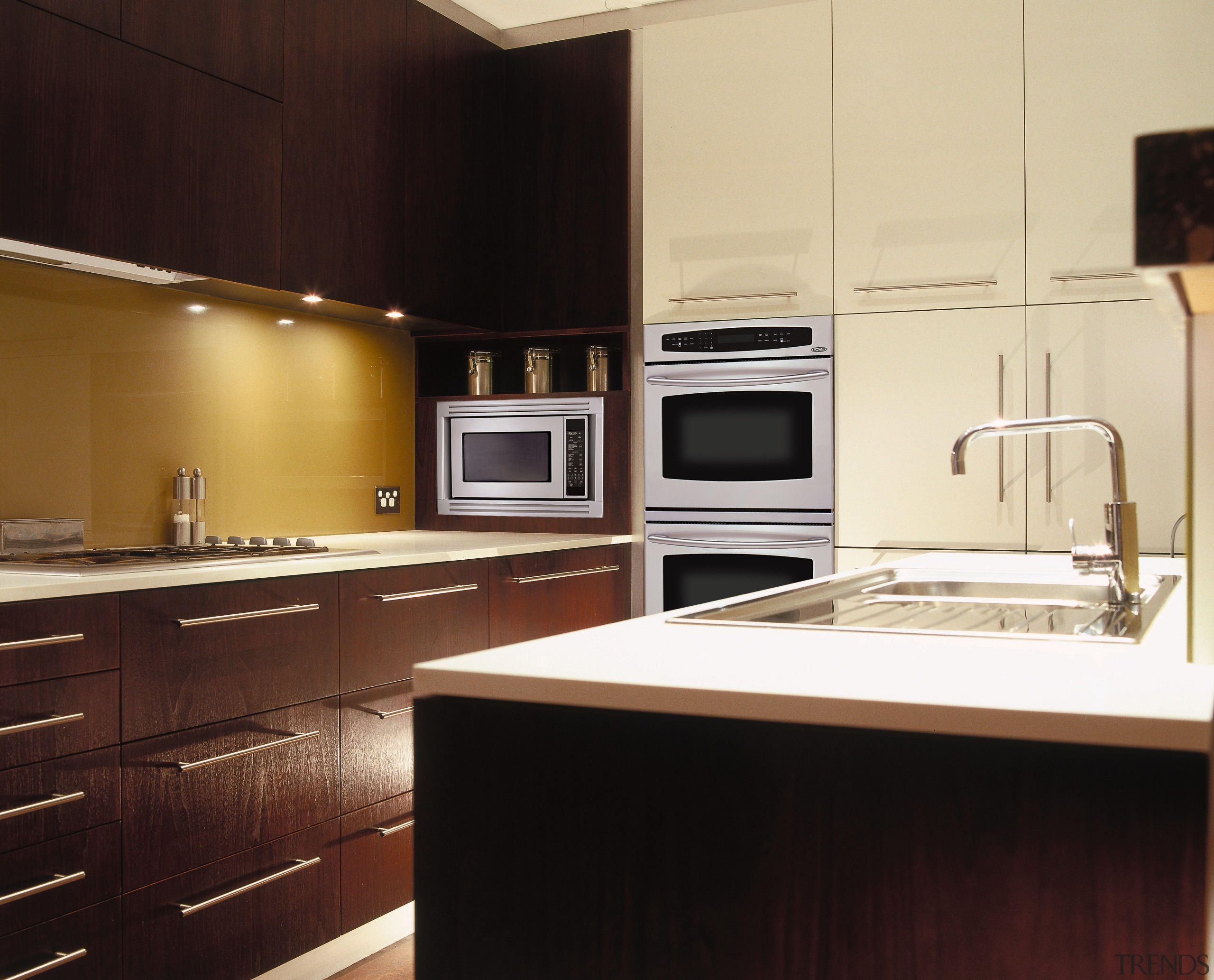 view of this kitchen featuring dcs stainless steel cabinetry, countertop, cuisine classique, home appliance, interior design, kitchen, room, under cabinet lighting, black, orange