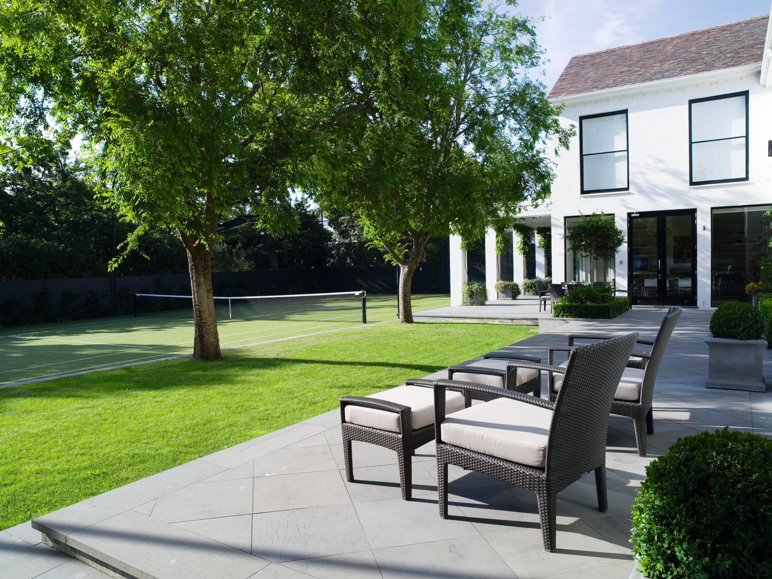 A view of the outdoor entertaining area featuring backyard, courtyard, estate, grass, home, house, landscaping, outdoor furniture, outdoor structure, property, real estate, residential area, walkway, yard, green, white