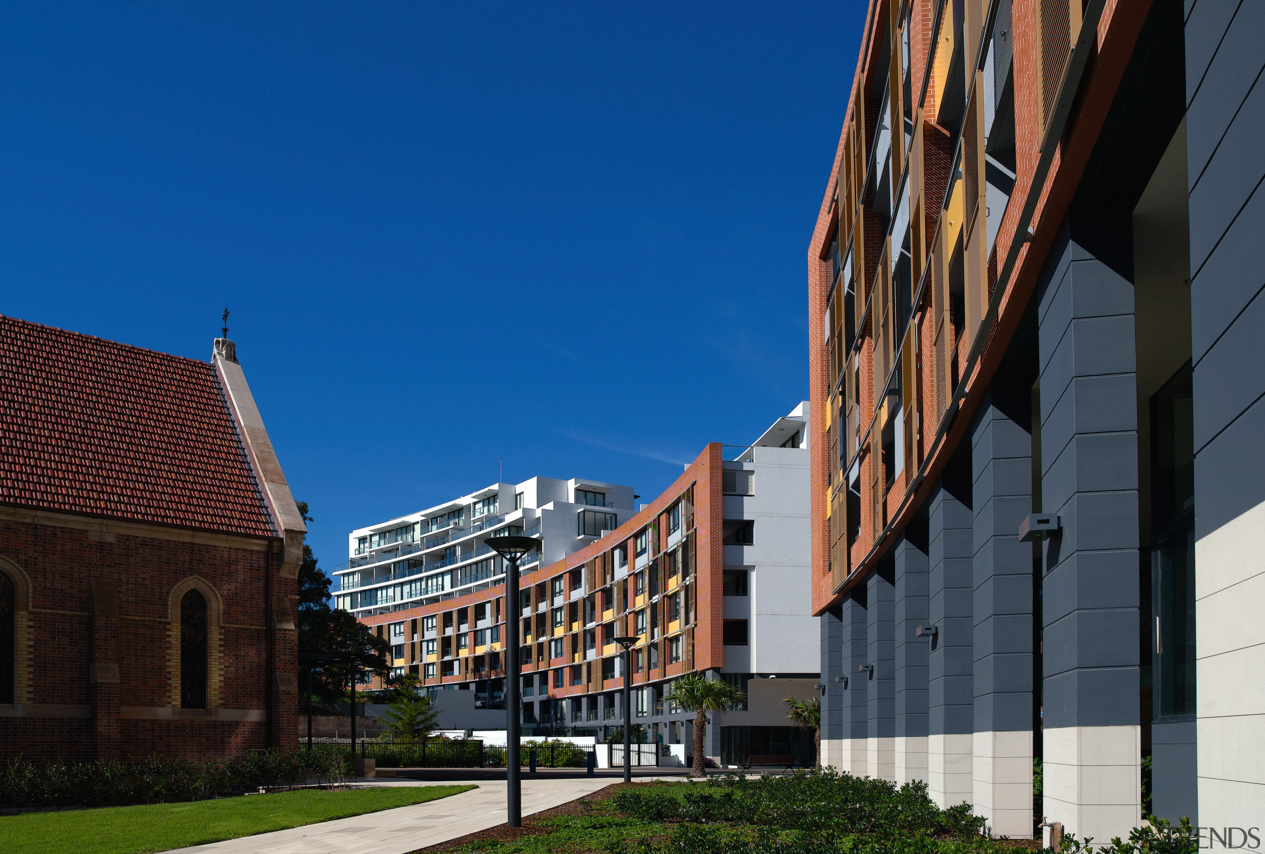 An exterior view of this multi storey apartment architecture, building, city, daytime, facade, house, metropolis, metropolitan area, mixed use, neighbourhood, residential area, sky, town, urban area, blue, black