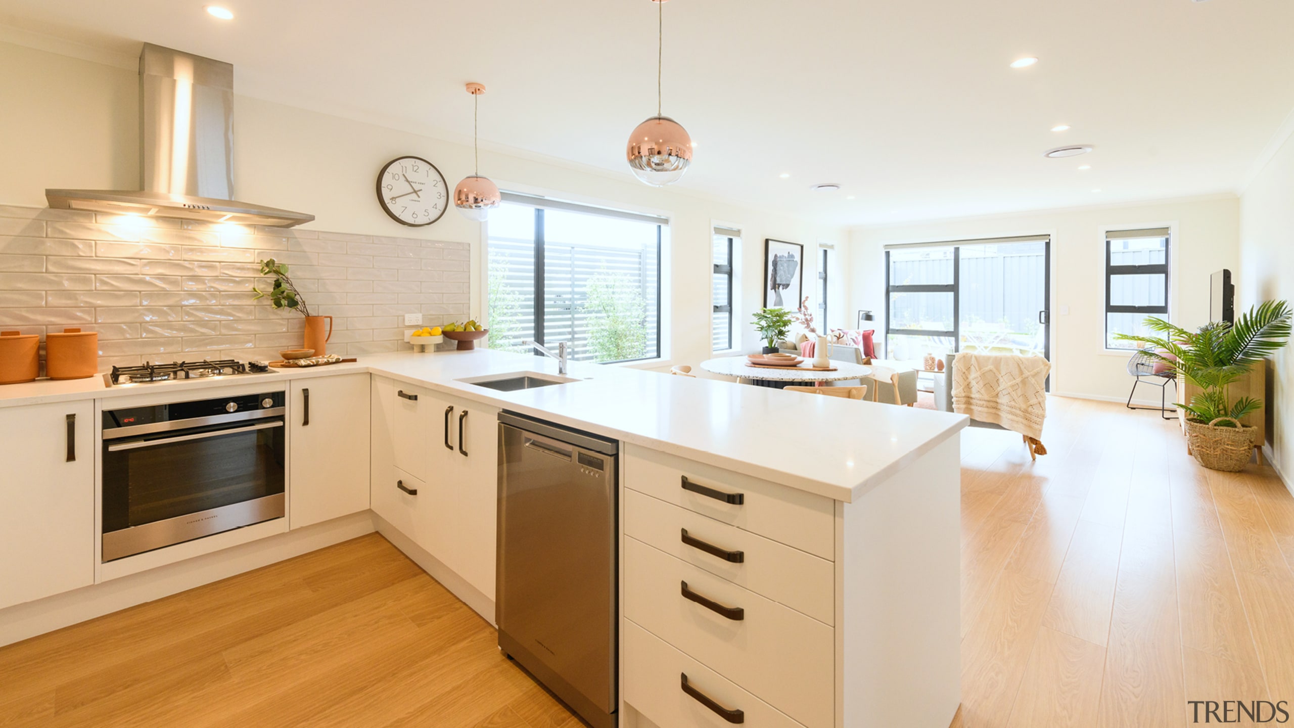 The white cabinetry and light-toned oak veneer floors 