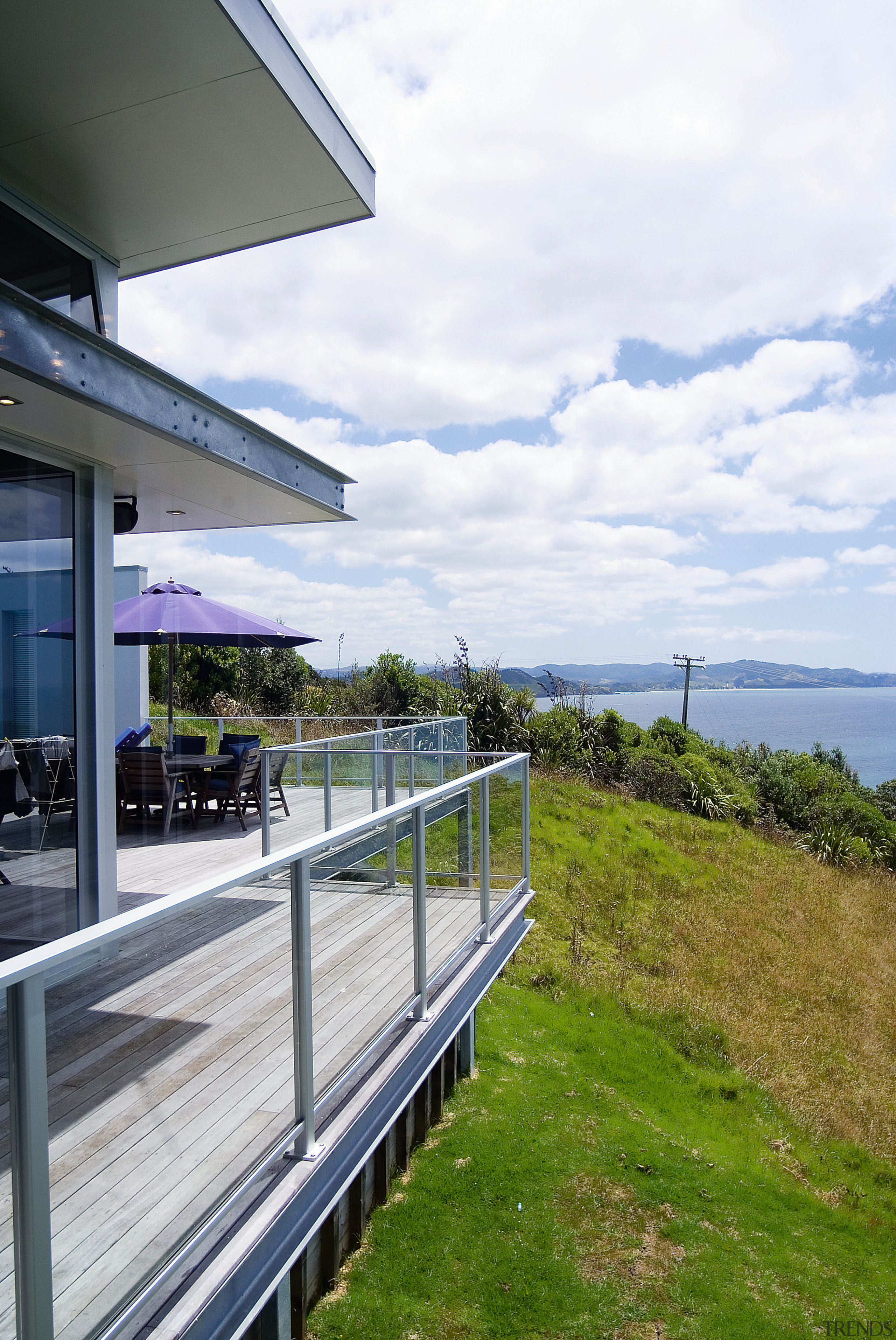 A view of a glass balustrade from Unex architecture, building, cloud, house, real estate, residential area, sky, white