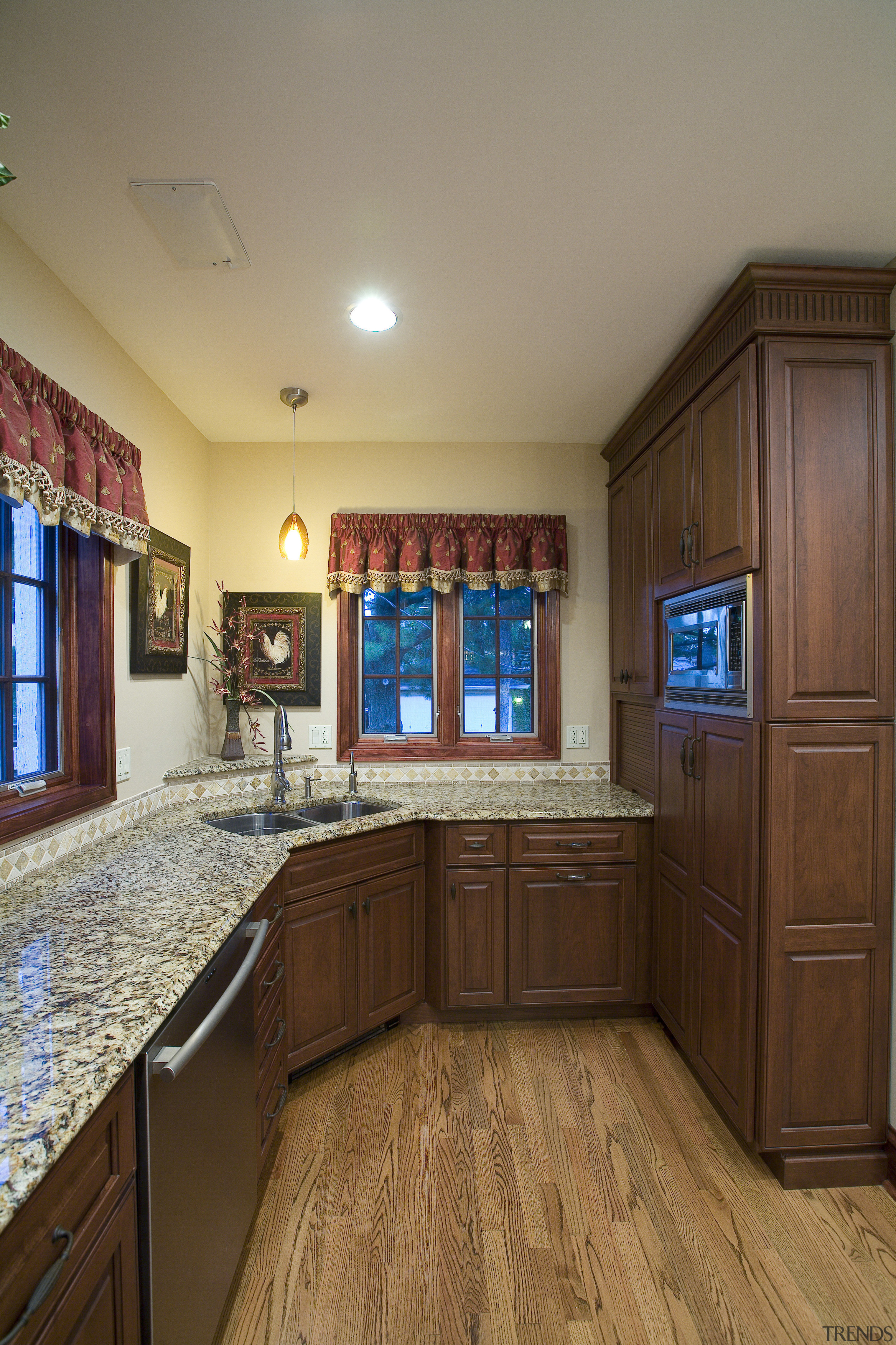 A view of this remodelled kitchen designed by cabinetry, ceiling, countertop, estate, floor, flooring, hardwood, home, interior design, kitchen, real estate, room, brown, gray