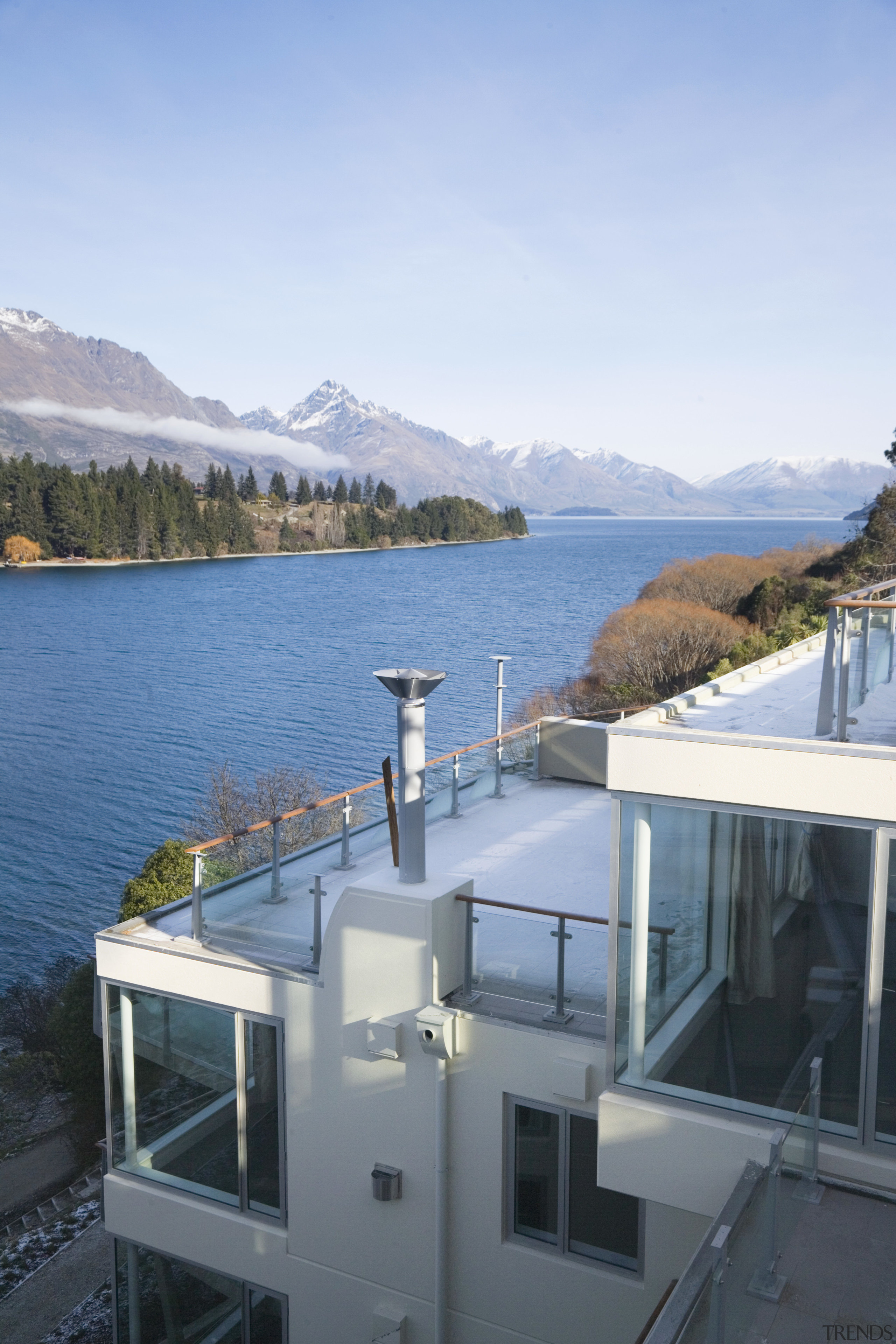 An exterior view of the Club apartments  architecture, glacial landform, home, house, lake, mountain, mountain range, property, real estate, roof, sea, sky, water, waterway, window, teal