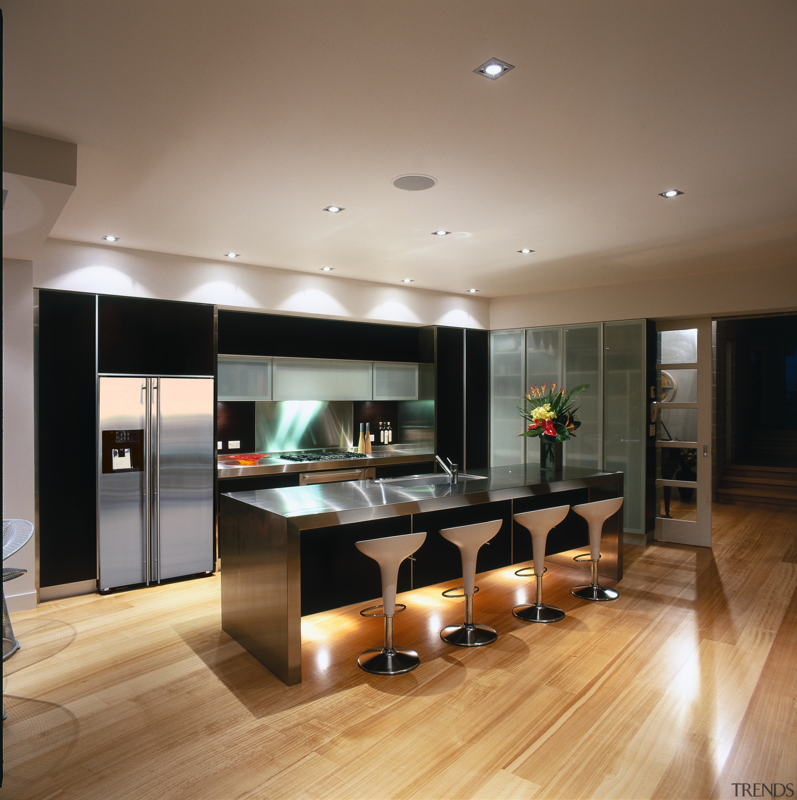 Kitchen with dark coloured cabinetry, stainless steel benchtop, ceiling, countertop, floor, flooring, hardwood, interior design, kitchen, laminate flooring, living room, wood flooring, brown, gray