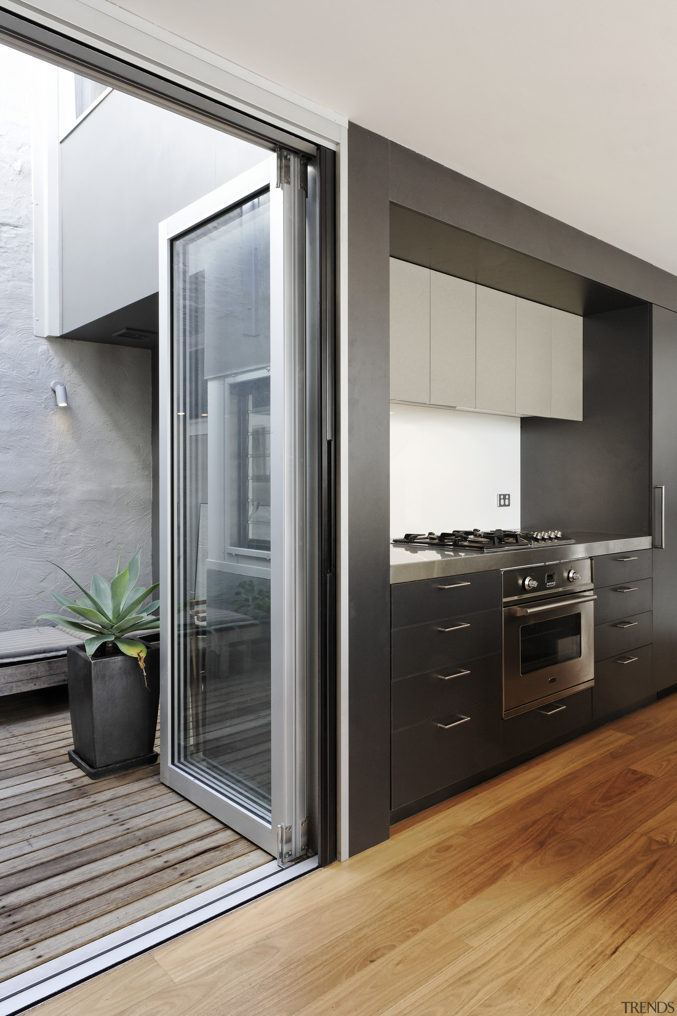 View of dark toned kitchen drawers and wooden door, home appliance, interior design, gray