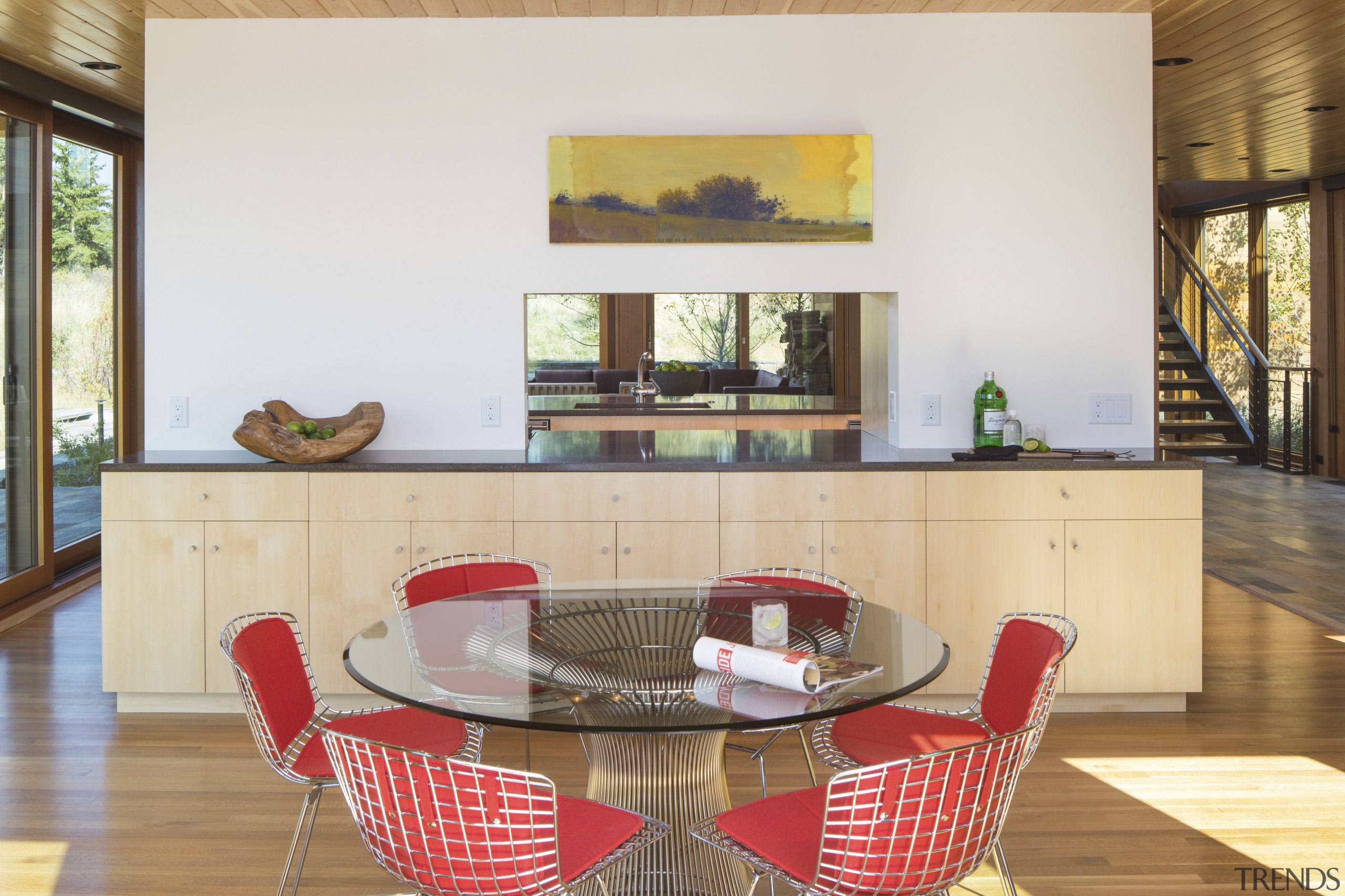 A pass-through in the great room of this chair, dining room, flooring, furniture, interior design, living room, property, real estate, room, table, white