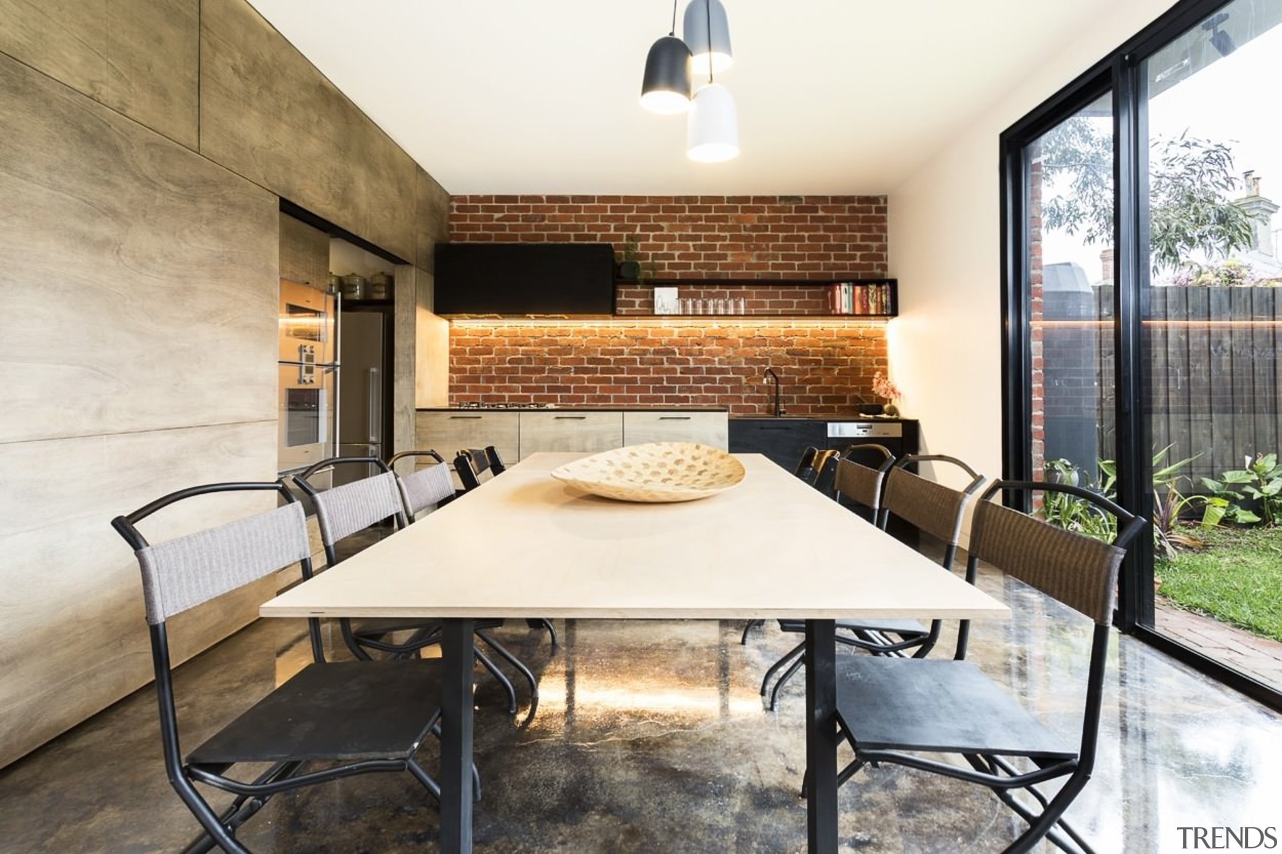 A dining/kitchen area opens out to the backyard architecture, house, interior design, real estate, table, white