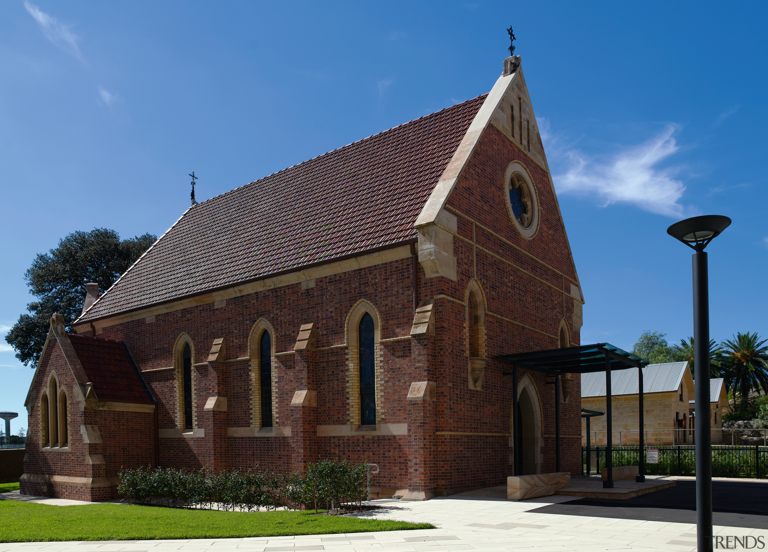 A view of this heritage protected church at building, chapel, church, facade, historic site, house, medieval architecture, parish, place of worship, roof, sky, black, teal