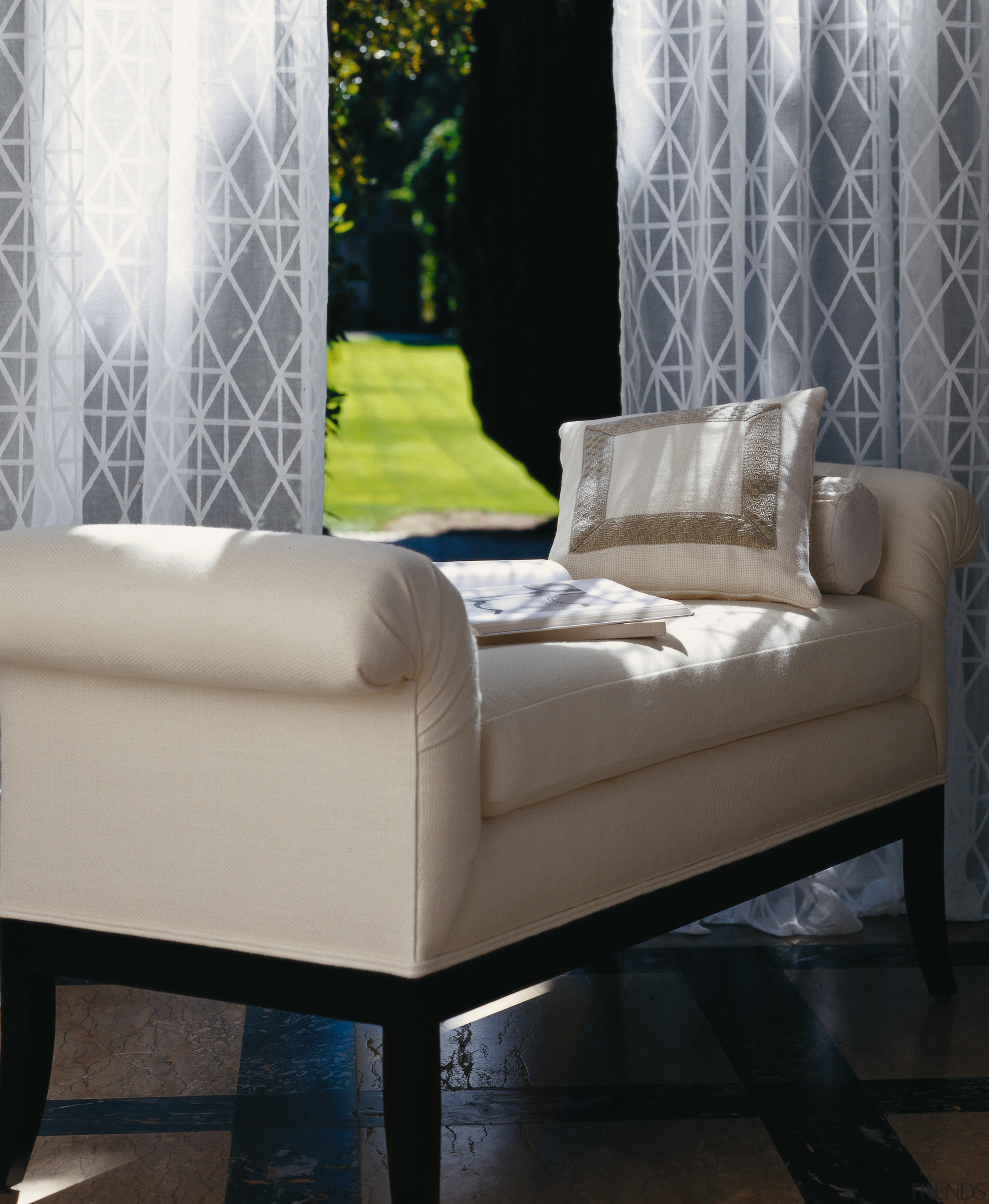 View of a living area, tiled floor, long bed frame, chair, coffee table, couch, floor, furniture, home, interior design, living room, loveseat, sofa bed, table, wall, window, window covering, window treatment, gray, black