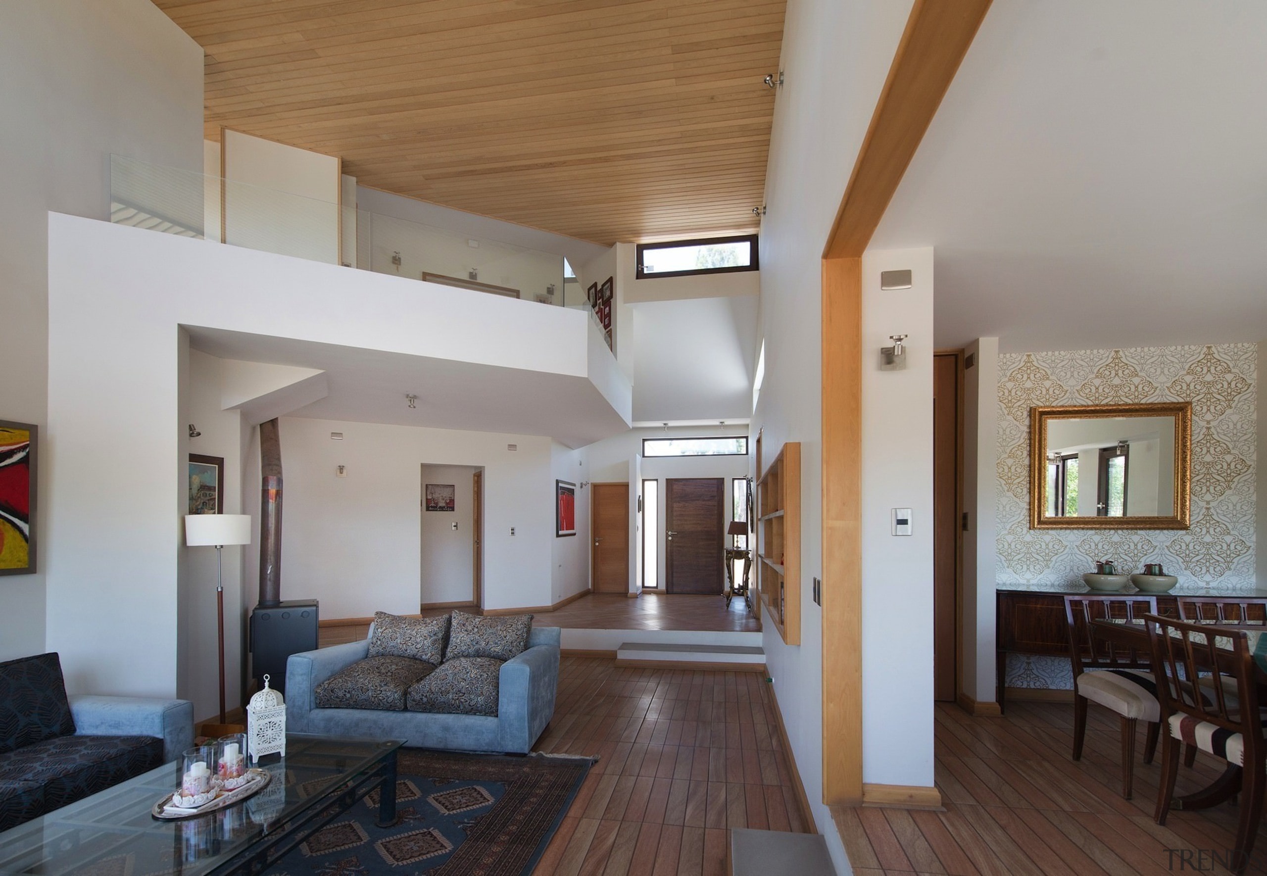 The dining area and entrance flow down to architecture, ceiling, daylighting, estate, floor, flooring, house, interior design, living room, property, real estate, room, gray