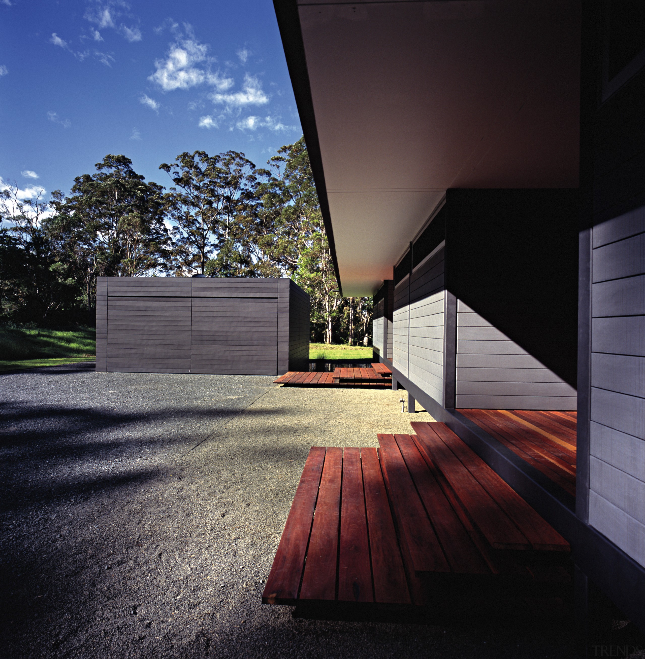 An exterior view of this architecturally designed home architecture, daylighting, facade, home, house, real estate, residential area, roof, sky, sunlight, wood, black