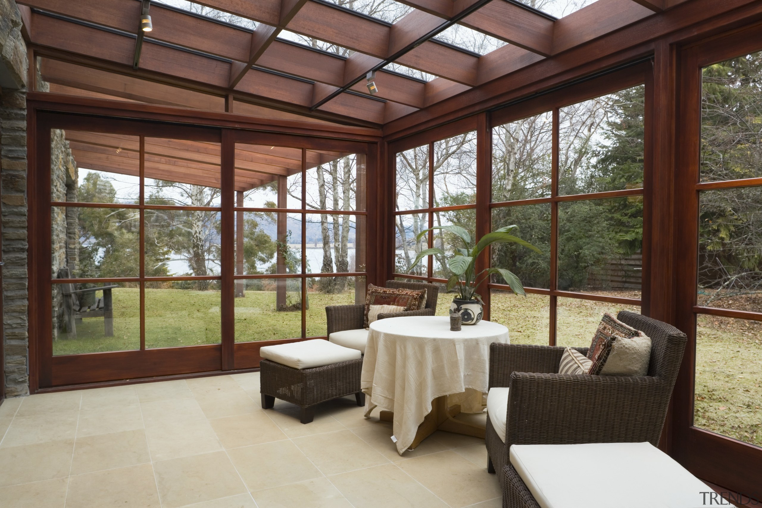 A view of the conservatory featuring dark stained daylighting, estate, house, interior design, outdoor structure, porch, property, real estate, roof, window, red