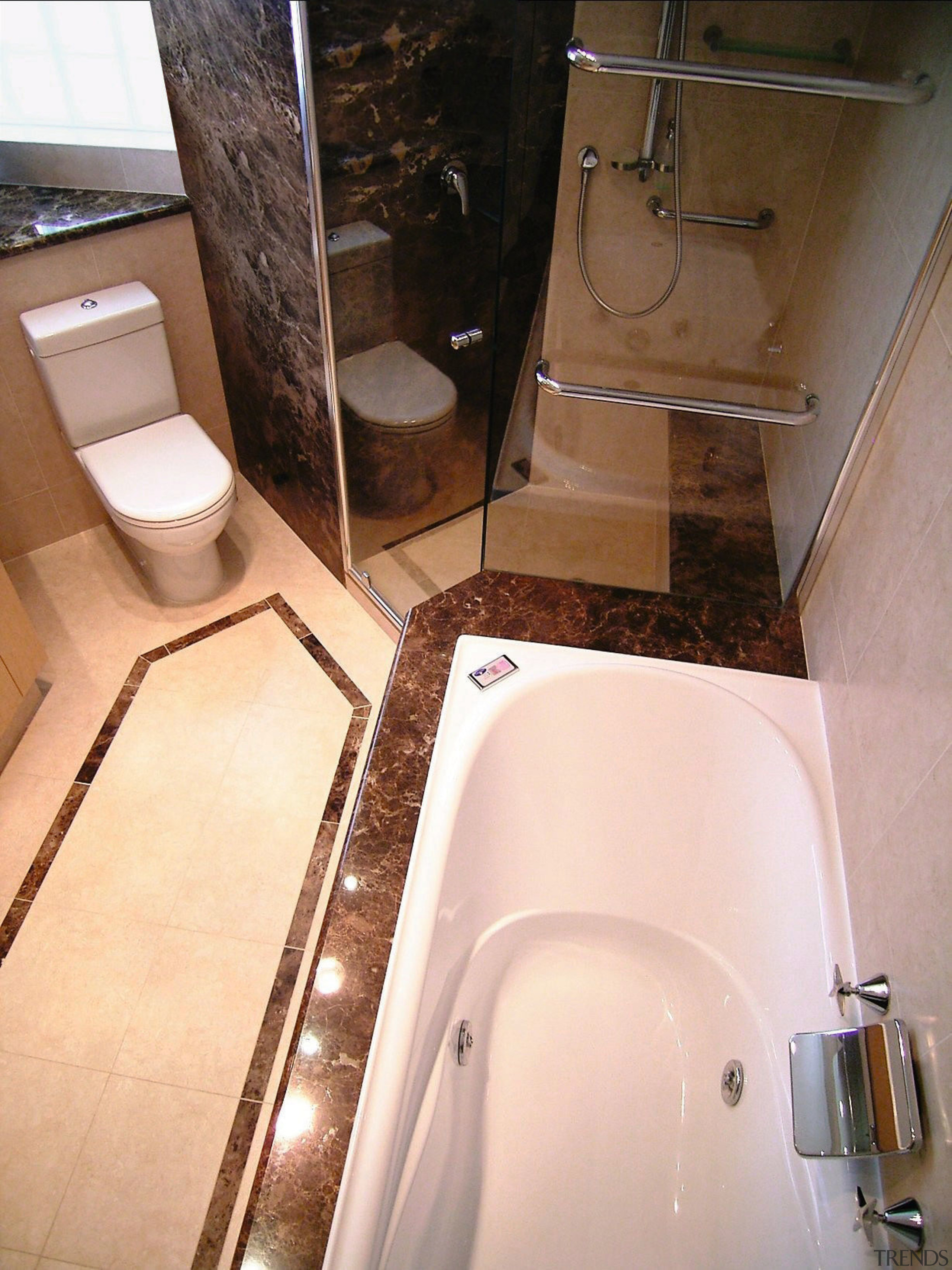 overhead view of the bathtub, showing brown stone bathroom, floor, plumbing fixture, property, room, sink, tile, toilet, toilet seat, orange, brown