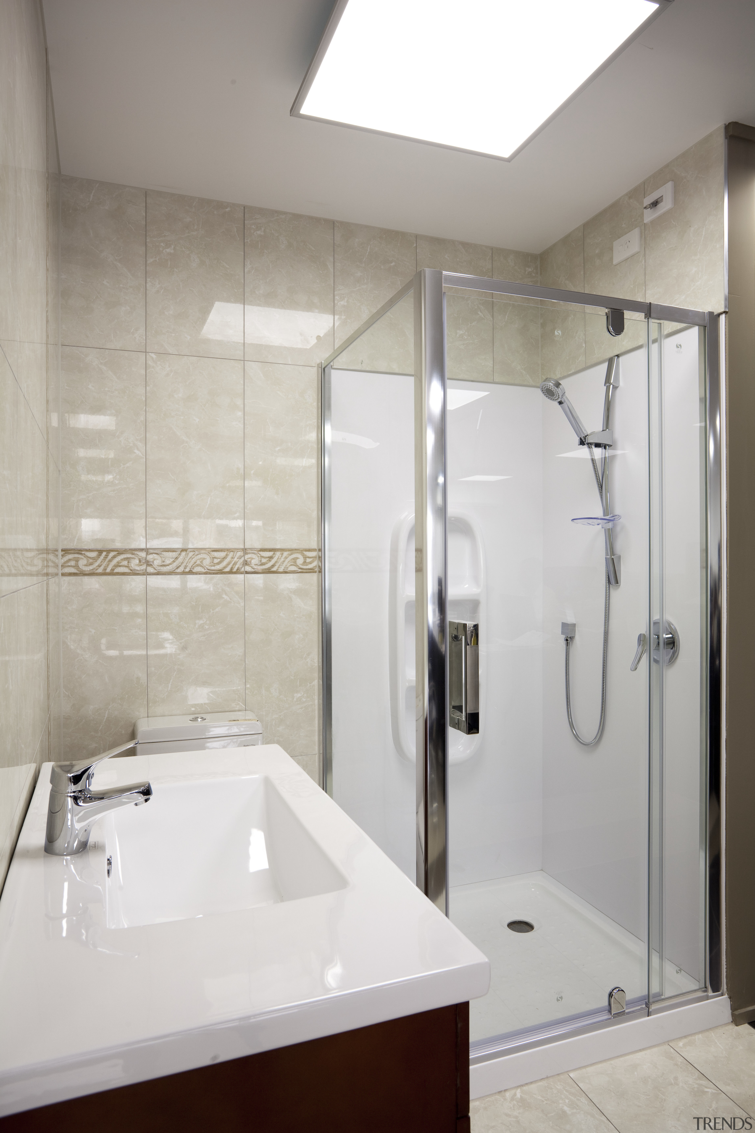 Bathroom with cream walls and white topped vanity. bathroom, bathroom accessory, interior design, plumbing fixture, product design, room, sink, tap, gray