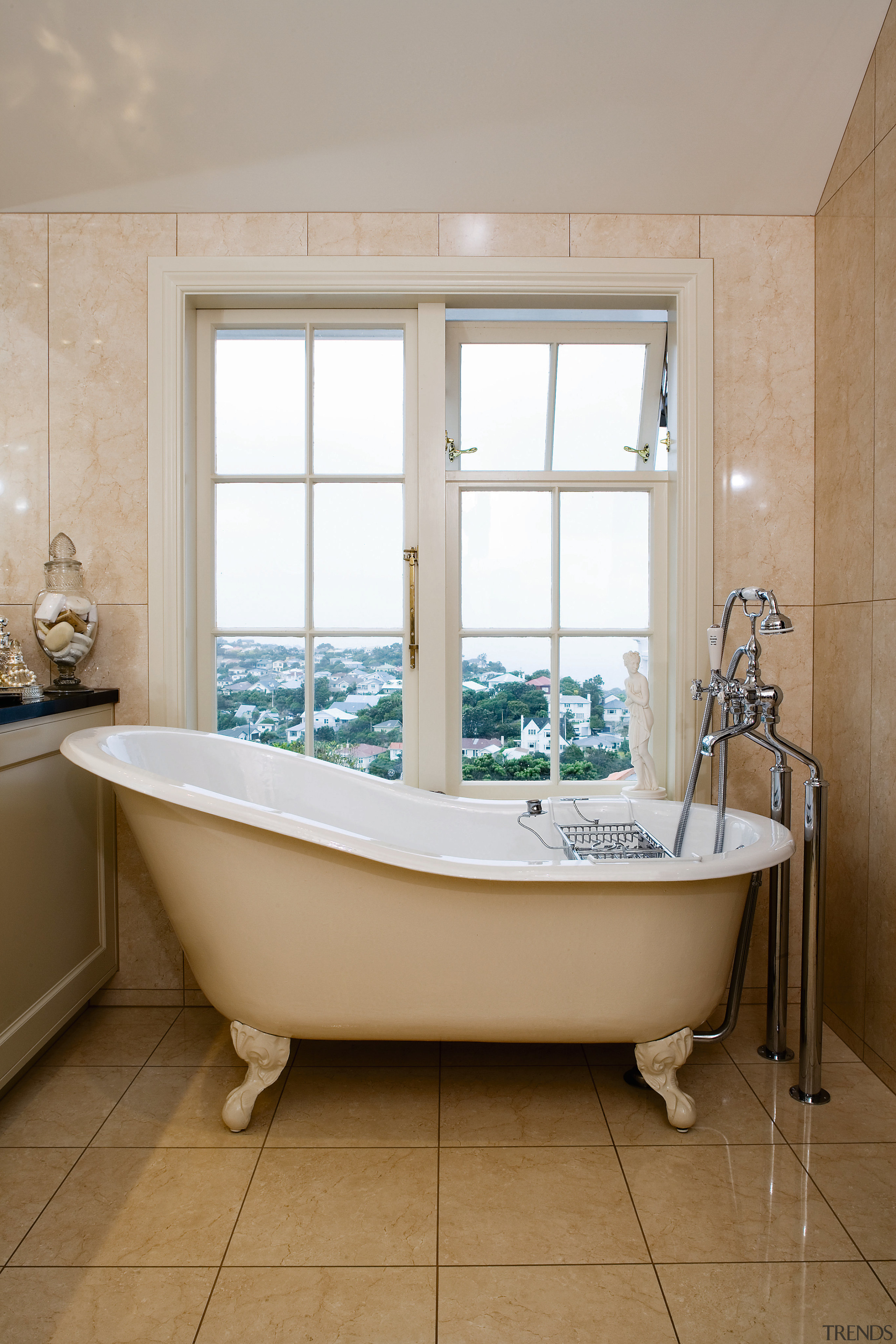 View of an old-fashioned freestanding bath tub on bathroom, bathtub, floor, home, interior design, plumbing fixture, product, room, tile, window, gray, brown