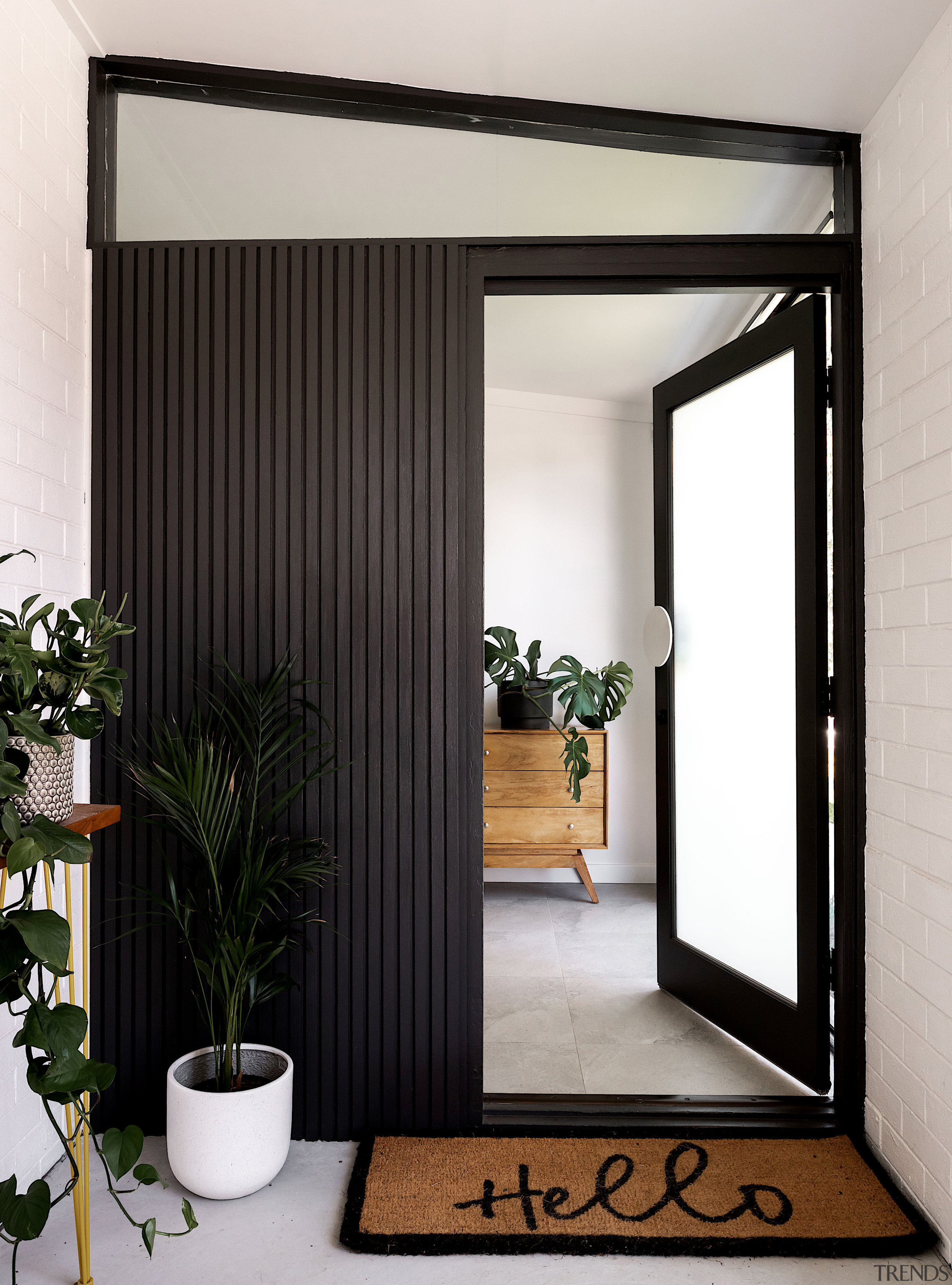 The entryway hints at the monochromatic palette that 