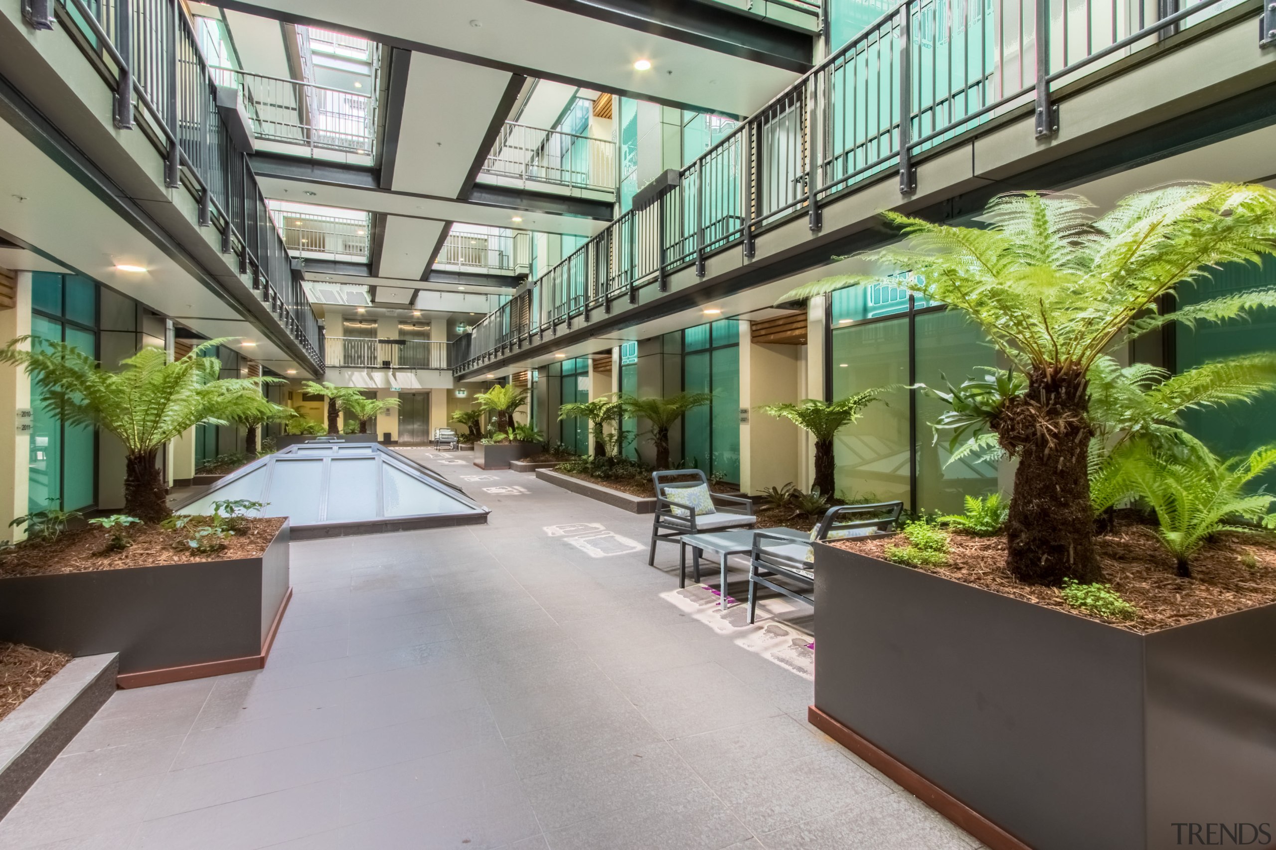 New atrium walkways provide access for the hotel apartment, condominium, courtyard, interior design, mixed use, plant, property, real estate, gray