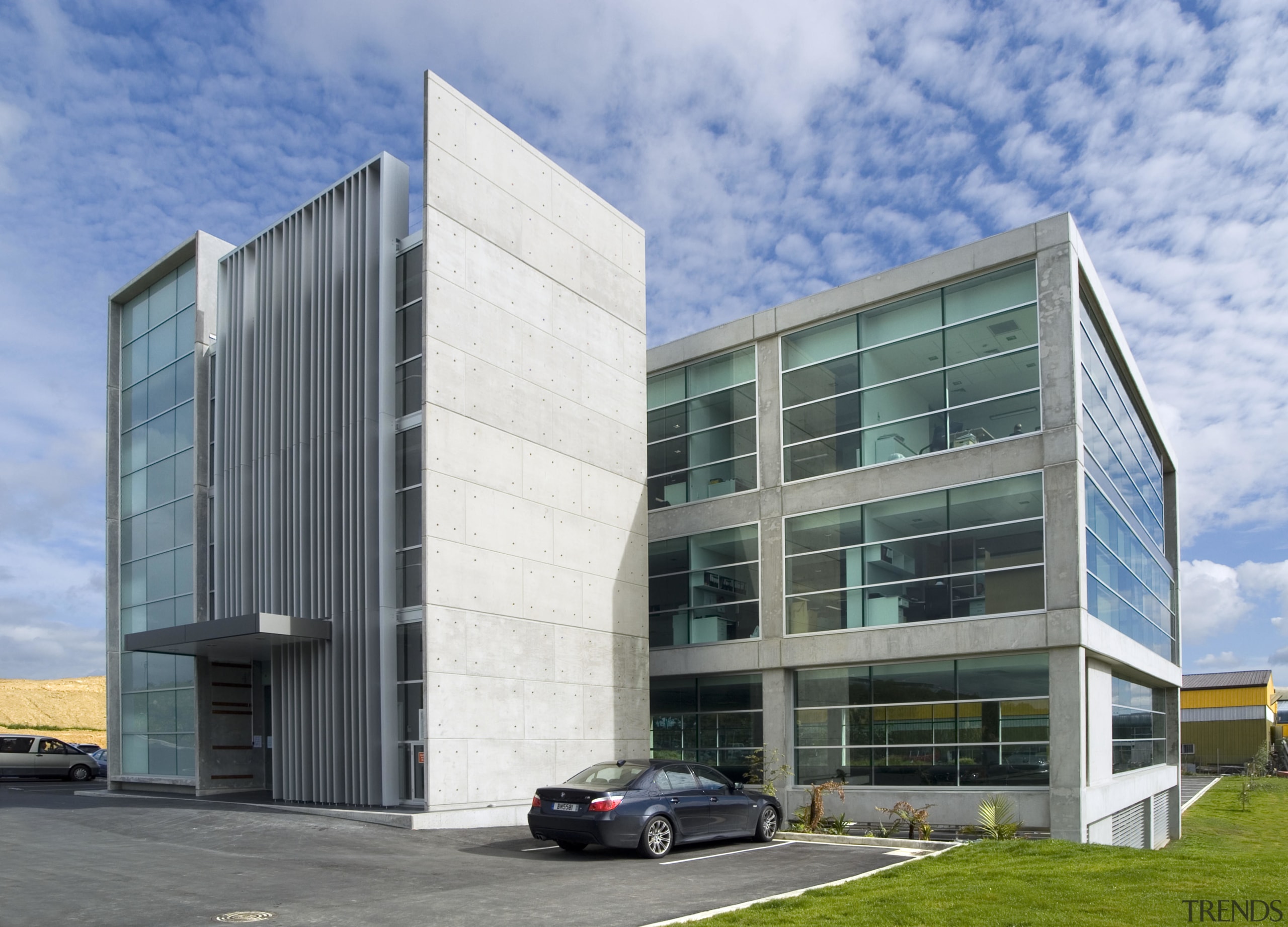 This sustainable office building in Auckland, the head architecture, building, commercial building, condominium, corporate headquarters, daytime, elevation, facade, headquarters, mixed use, real estate, sky, teal, gray