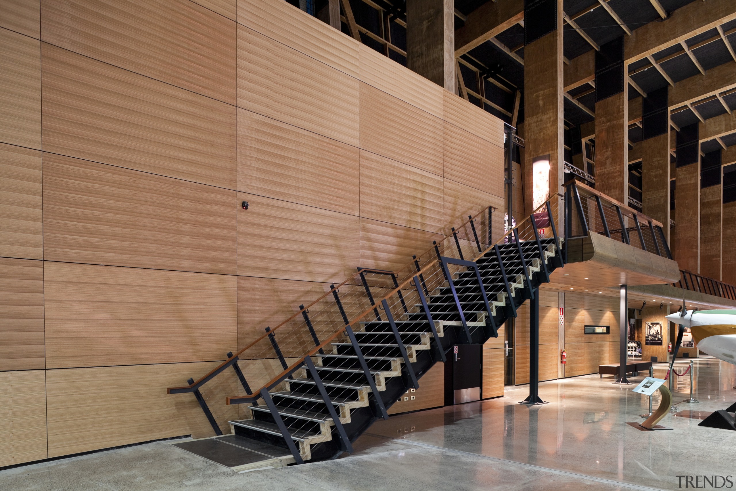 The acoustic timber panelling seen here in this architecture, handrail, stairs, structure, wall, wood, brown, orange