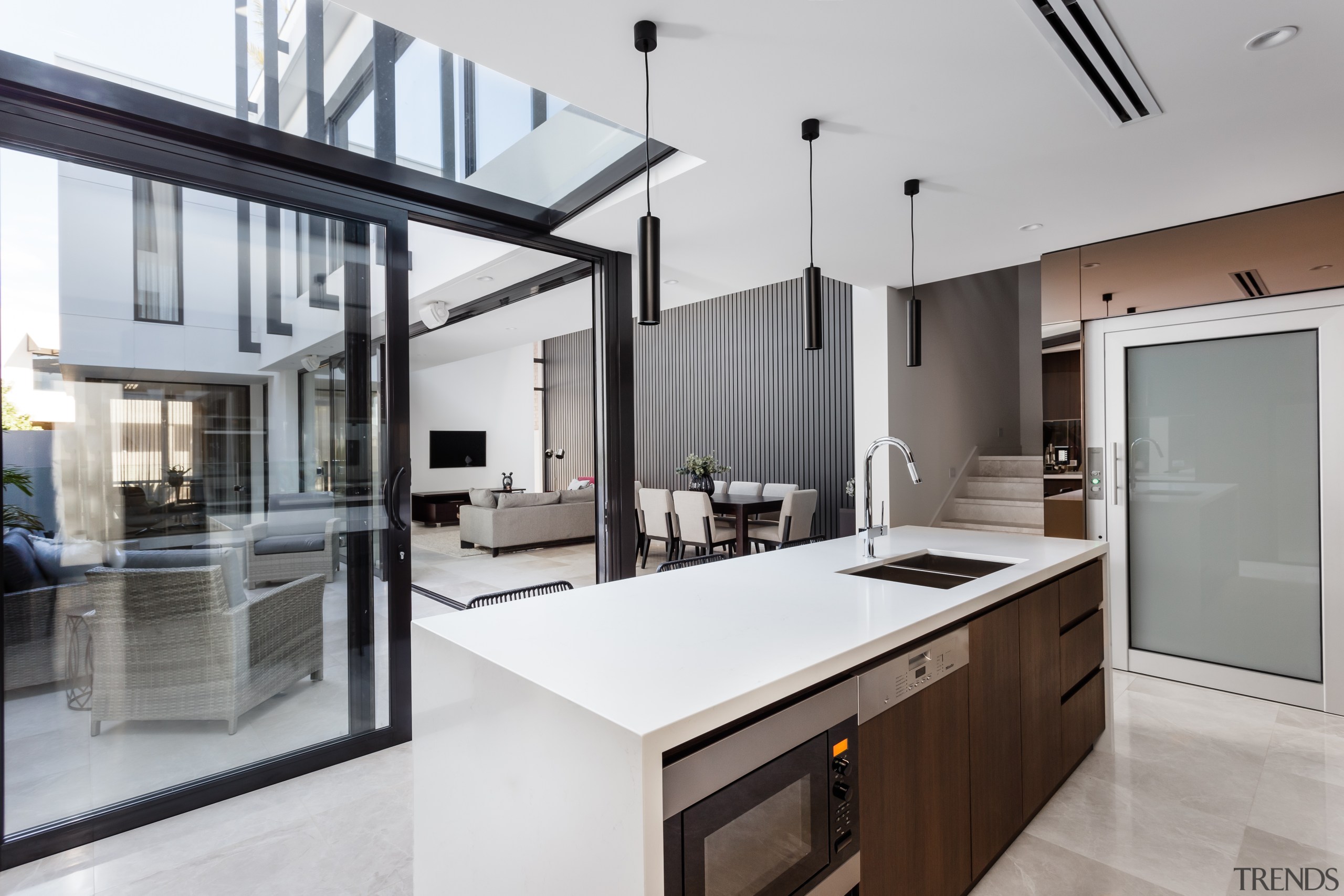 Sliding doors in front of this kitchen open countertop, house, interior design, kitchen, real estate, gray, white