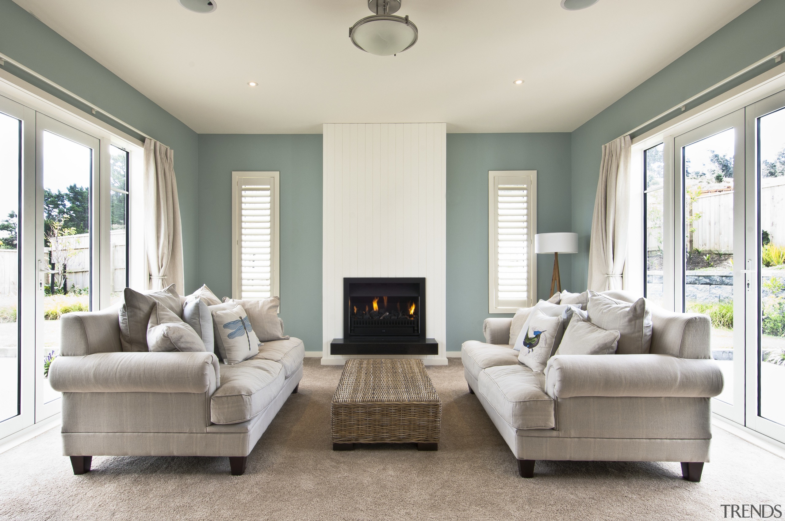 fireplace between two couches, green and white walls ceiling, estate, floor, home, interior design, living room, property, real estate, room, window, white, gray