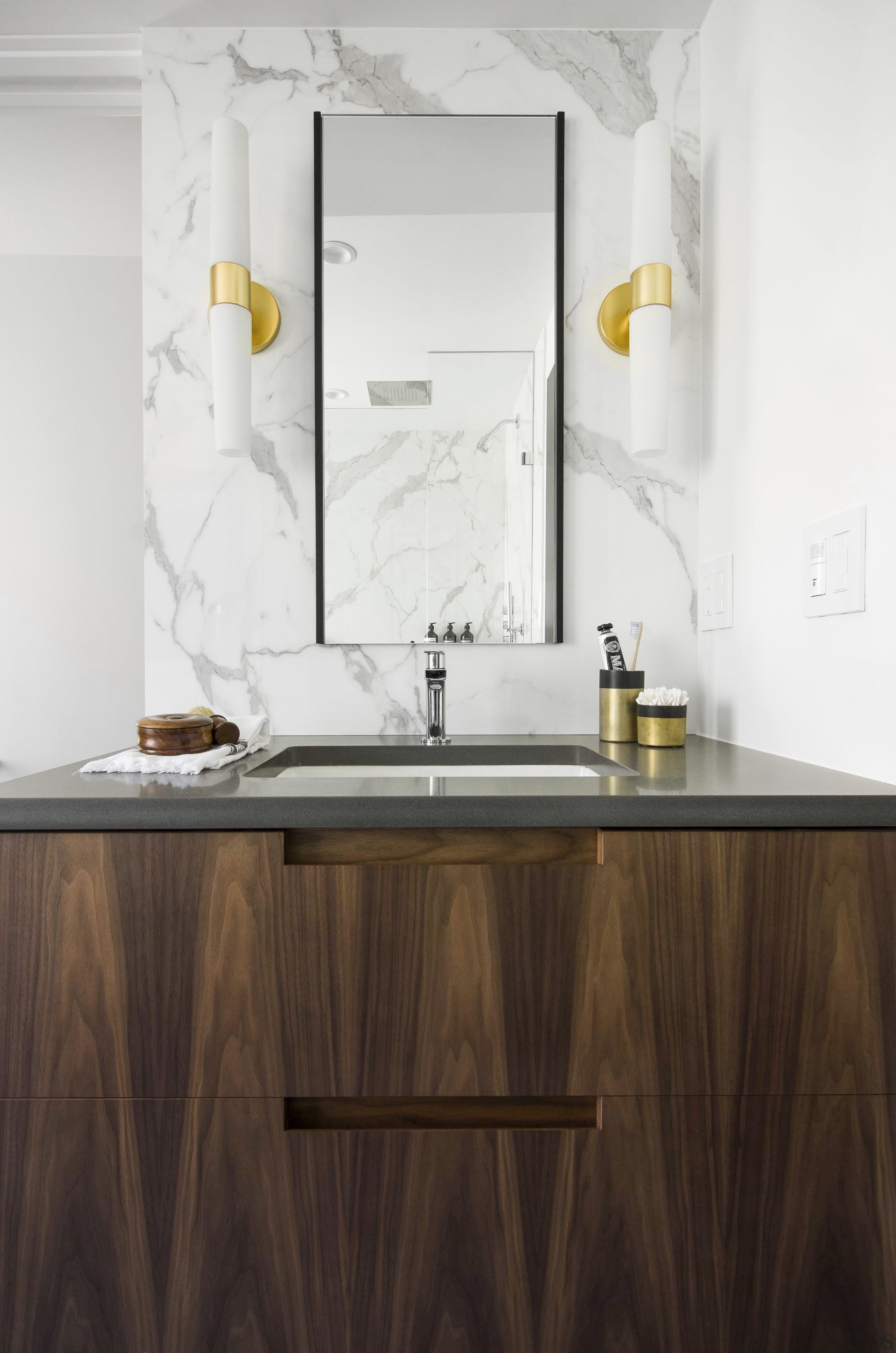 The custom walnut his and her vanities feature 