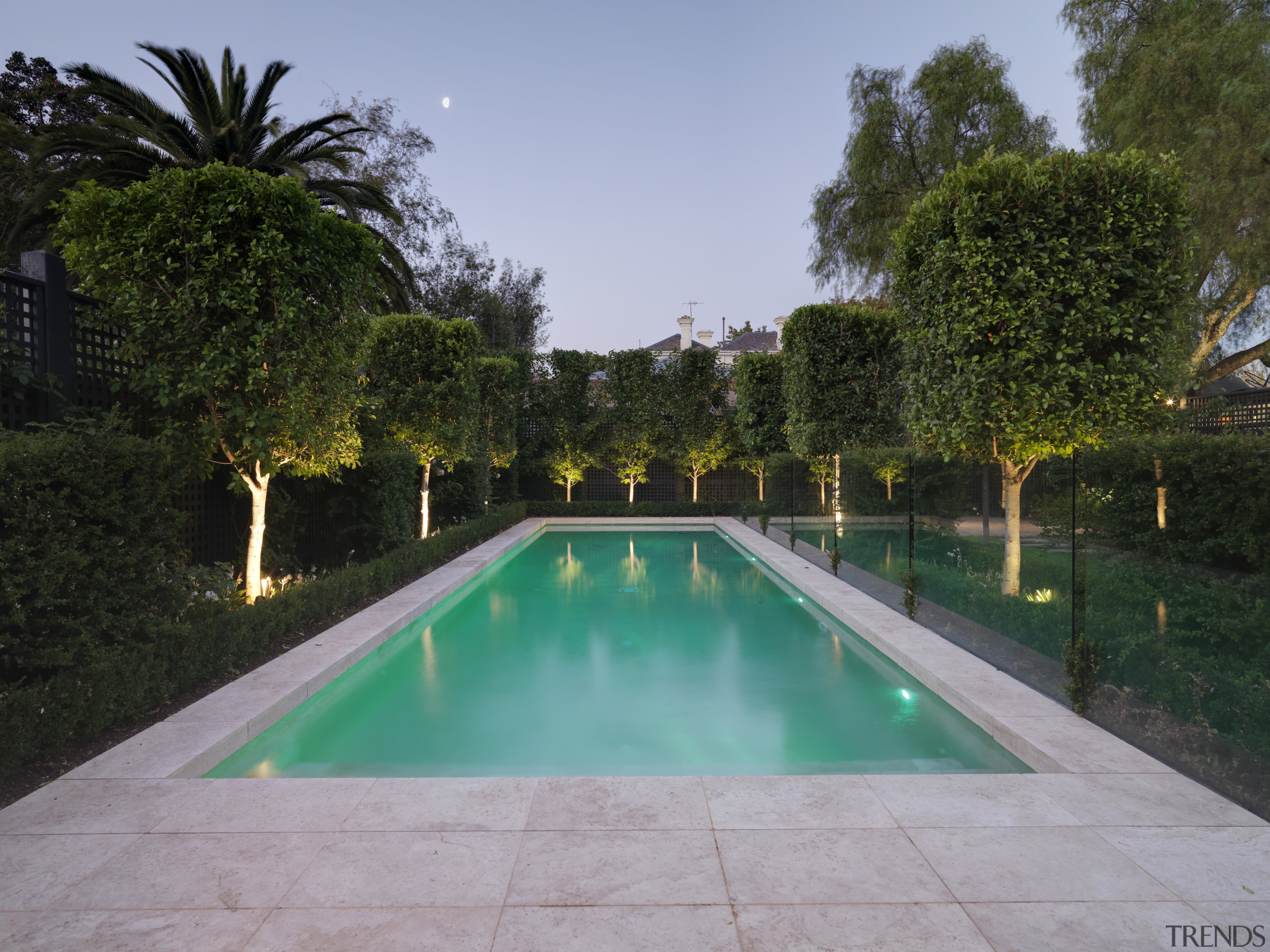 View of the pool which is surrounded by backyard, estate, grass, hacienda, leisure, plant, property, real estate, reflecting pool, reflection, resort, swimming pool, tree, villa, water, water feature, teal