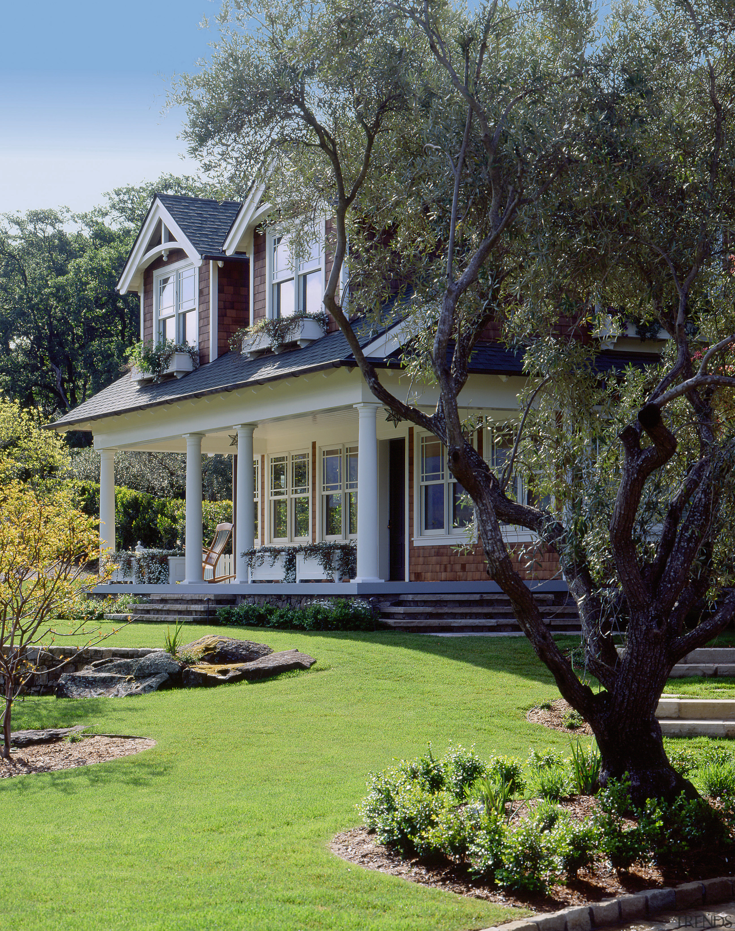 An exterior view of this traditional masonry home backyard, cottage, estate, facade, farmhouse, garden, grass, historic house, home, house, landscape, landscaping, lawn, mansion, outdoor structure, plant, plantation, property, real estate, residential area, siding, tree, yard