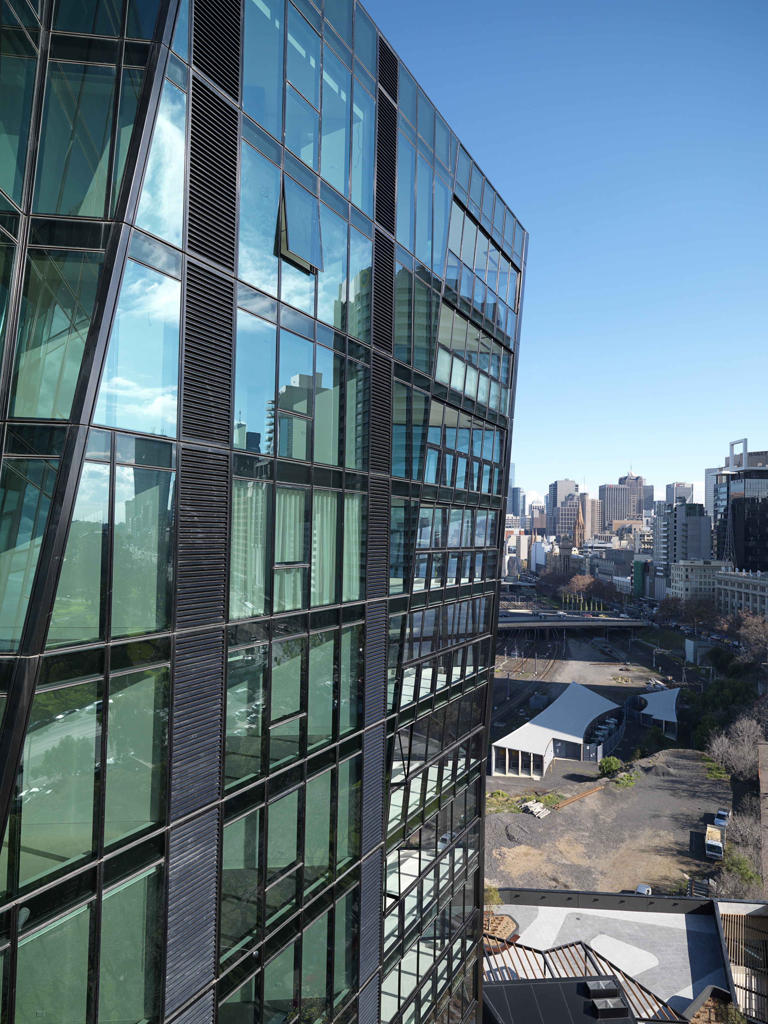 Exterior view of One East Melbourne developed by apartment, architecture, building, city, cityscape, commercial building, condominium, corporate headquarters, daytime, downtown, facade, headquarters, landmark, metropolis, metropolitan area, mixed use, neighbourhood, reflection, residential area, sky, skyscraper, tower block, urban area, window, teal, black