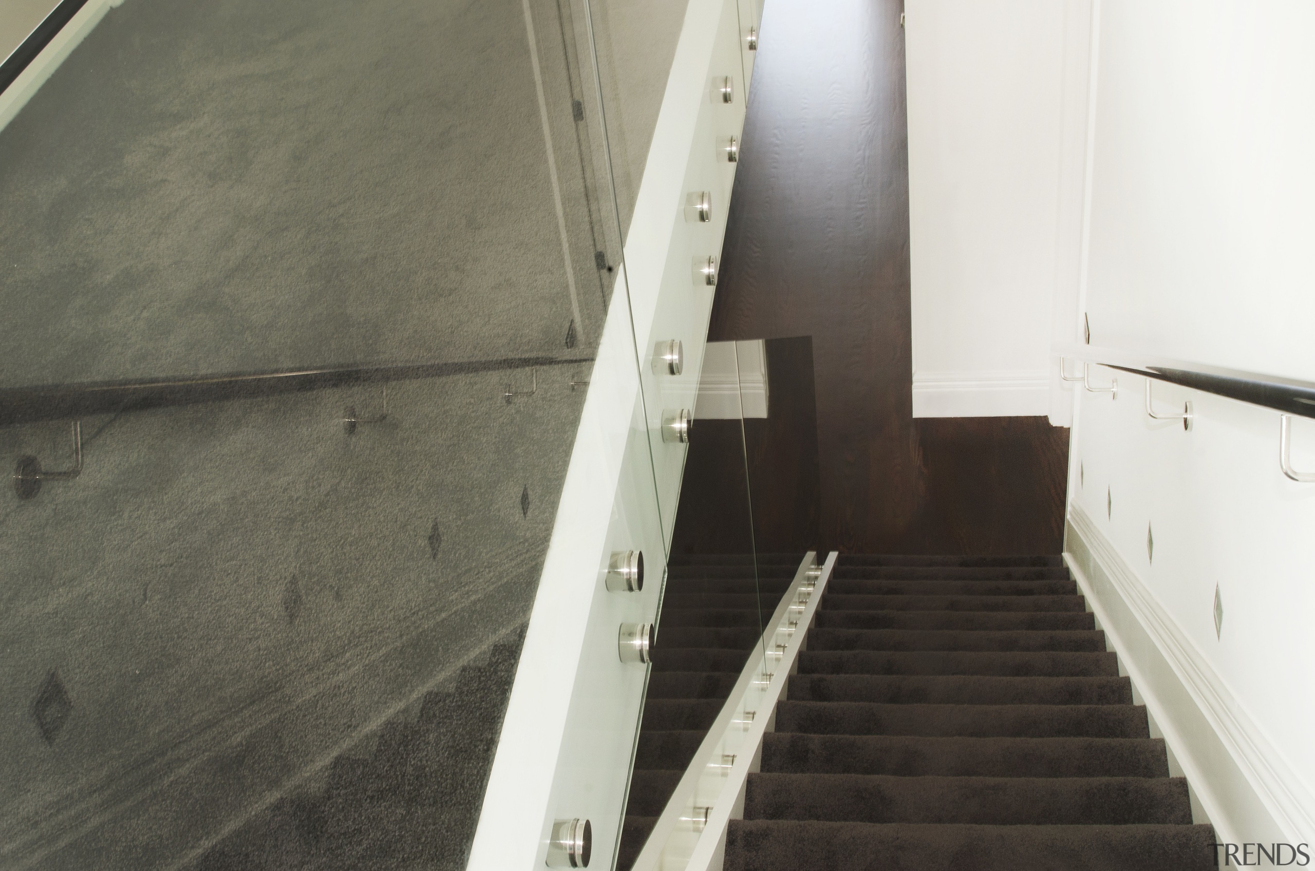 View down carpeted stairs. - View down carpeted floor, flooring, handrail, property, stairs, wall, wood, gray, white, black