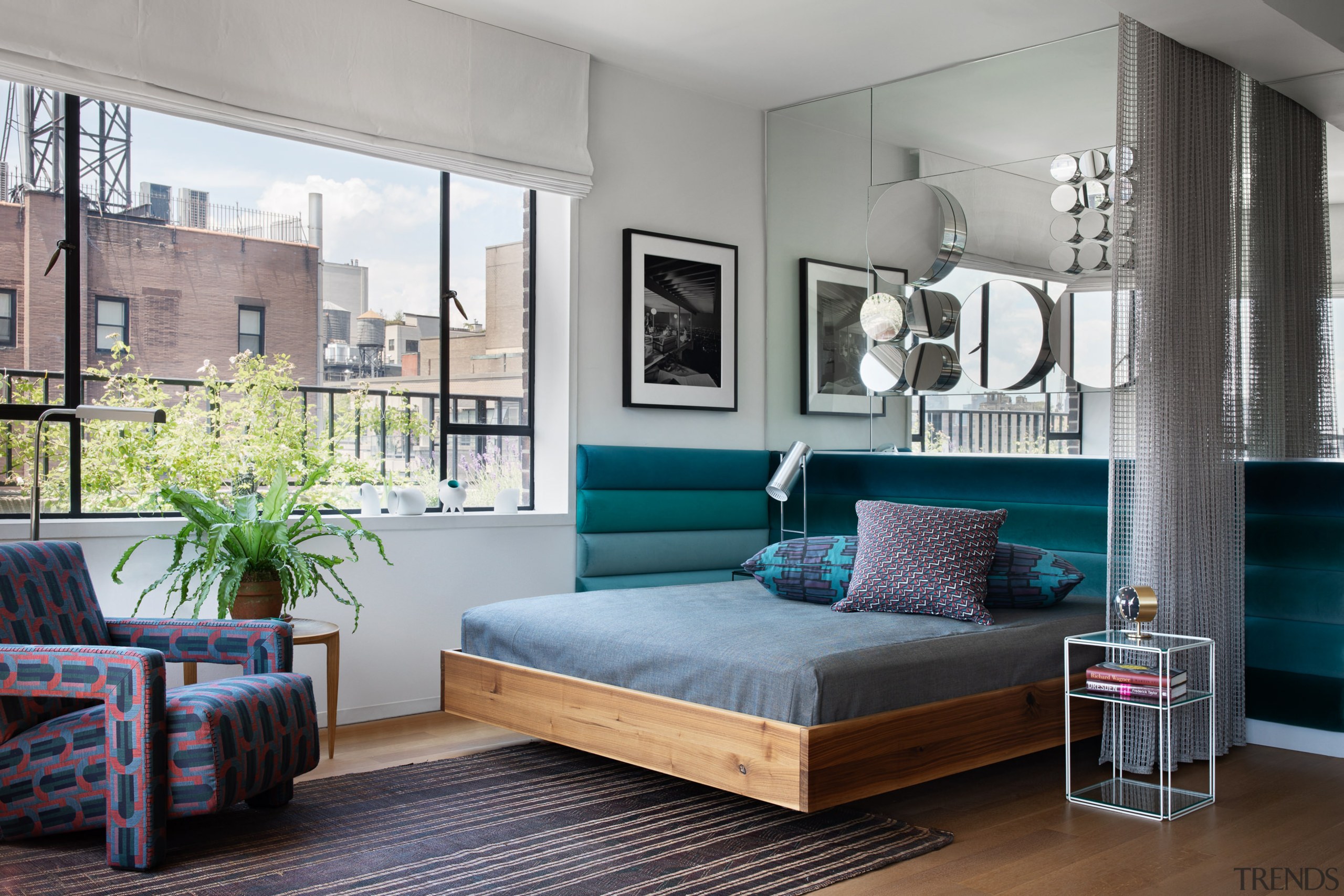 The cantilevered bed and mirror wall both add 